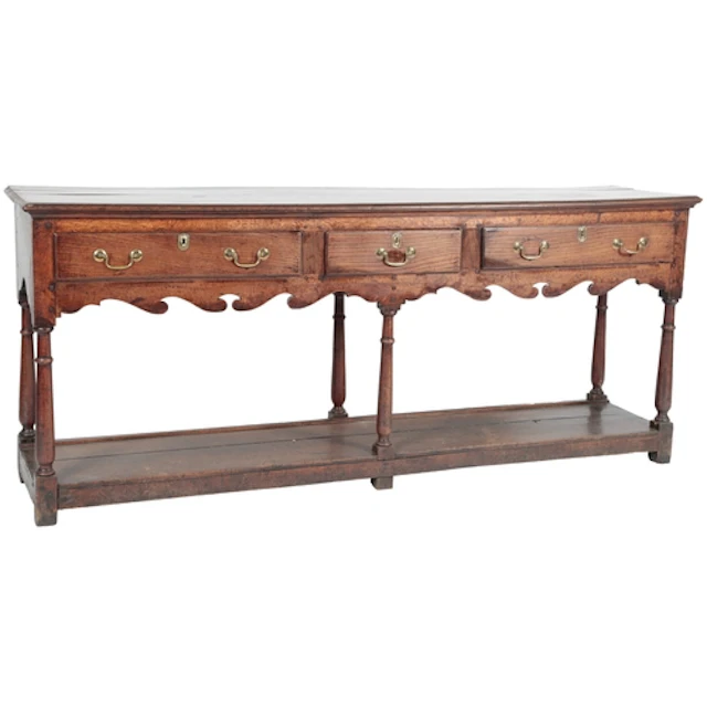 A George III oak potboard low dresser, the top with moulded ...