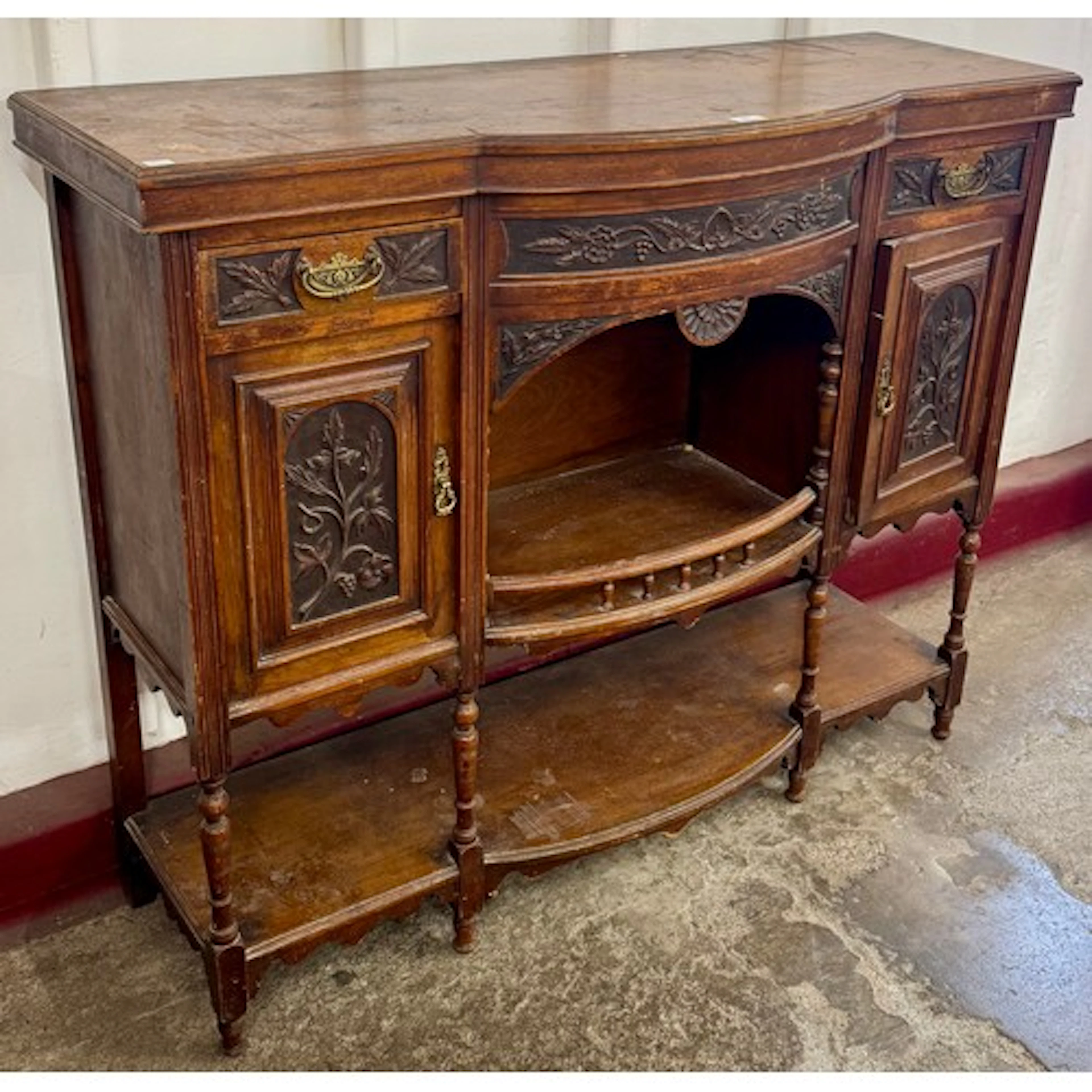 An Edward VII carved walnut side cabinet