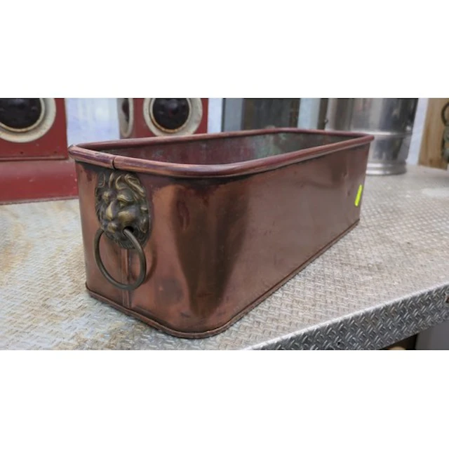 Copper jardinière with a brass lion-mask ring handle to both...