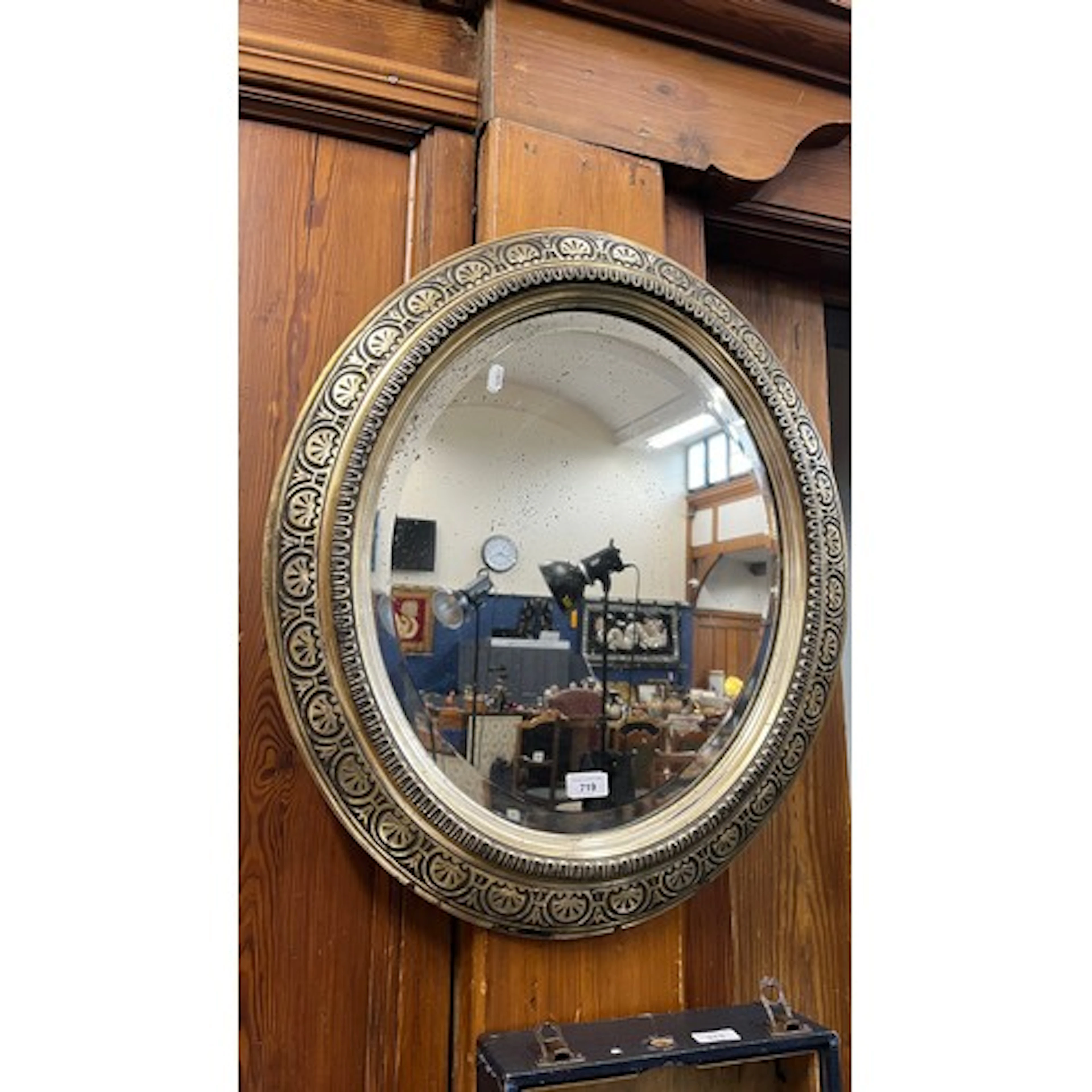 Wall mirror with symmetrical border design.