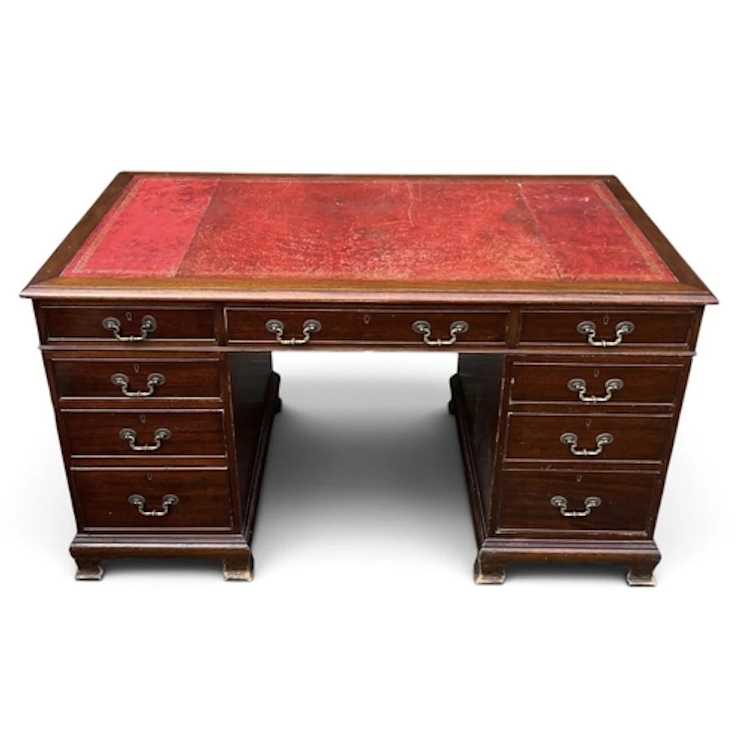 A TWIN PEDESTAL KNEEHOLE DESK With tooled red leather top. R...