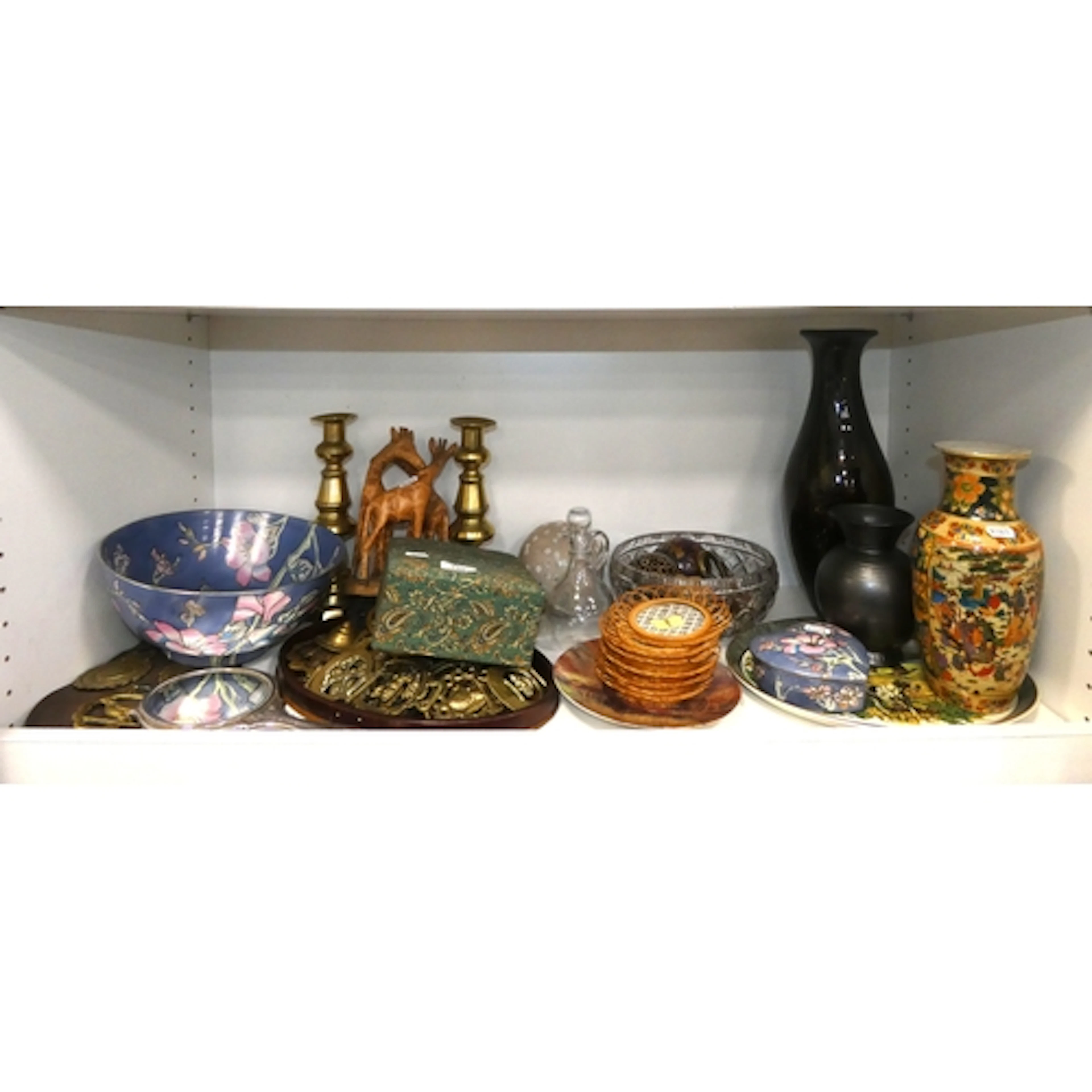 Shelf of sundries to include vanity mirror, horse brasses, a...