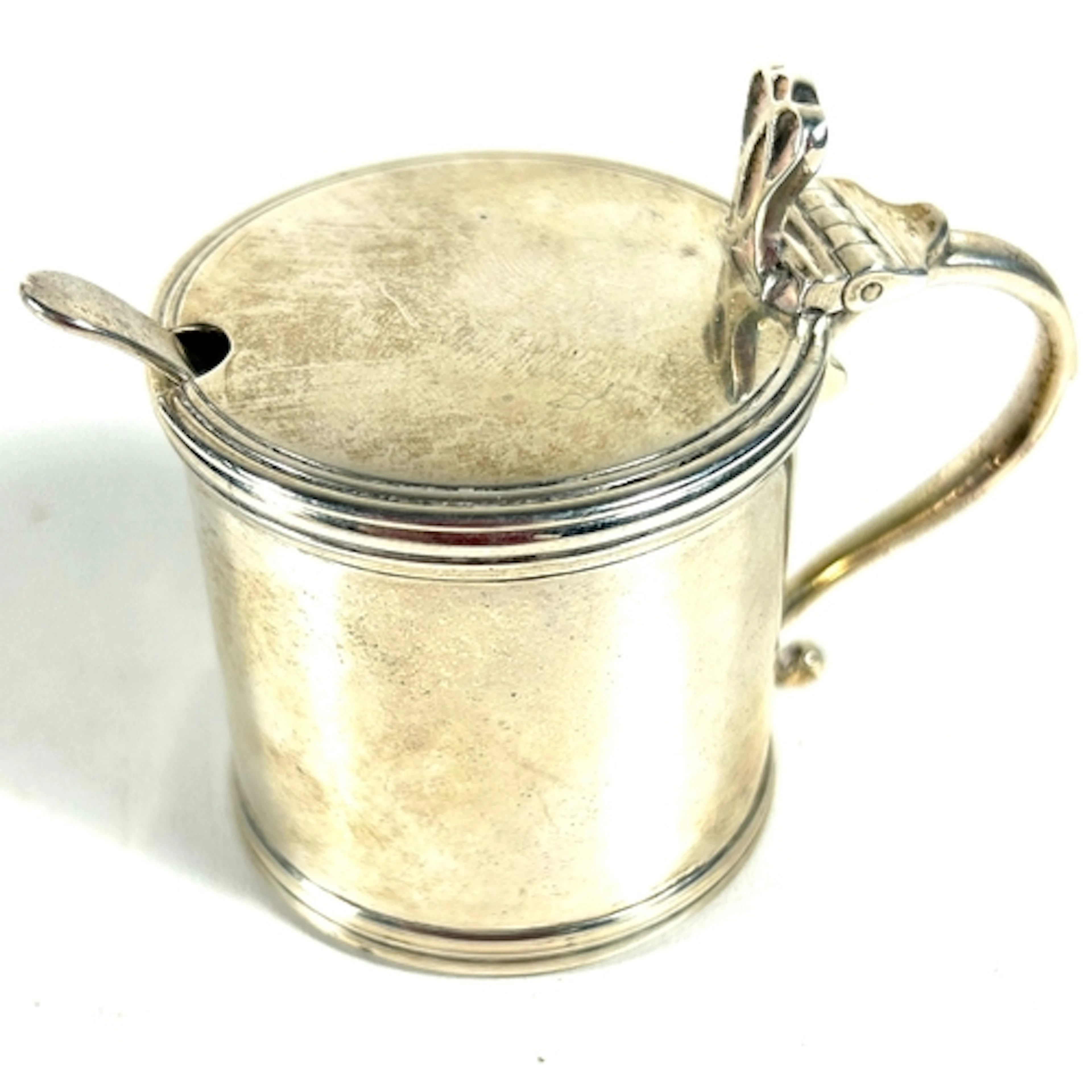 A silver mustard pot and spoon, missing liner, of plain des...