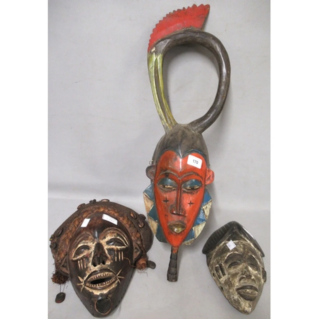 Three various native carved wooden wall masks