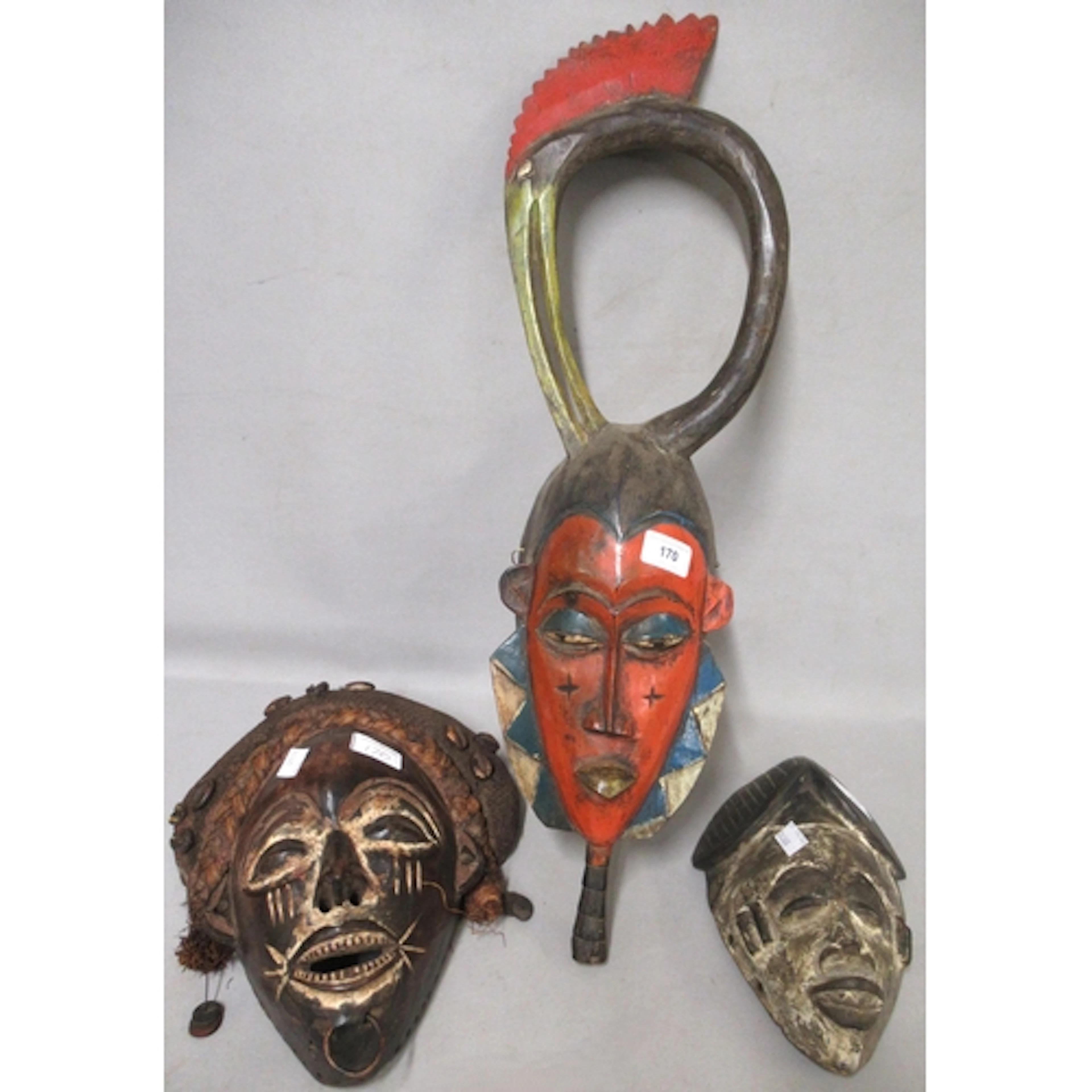 Three various native carved wooden wall masks