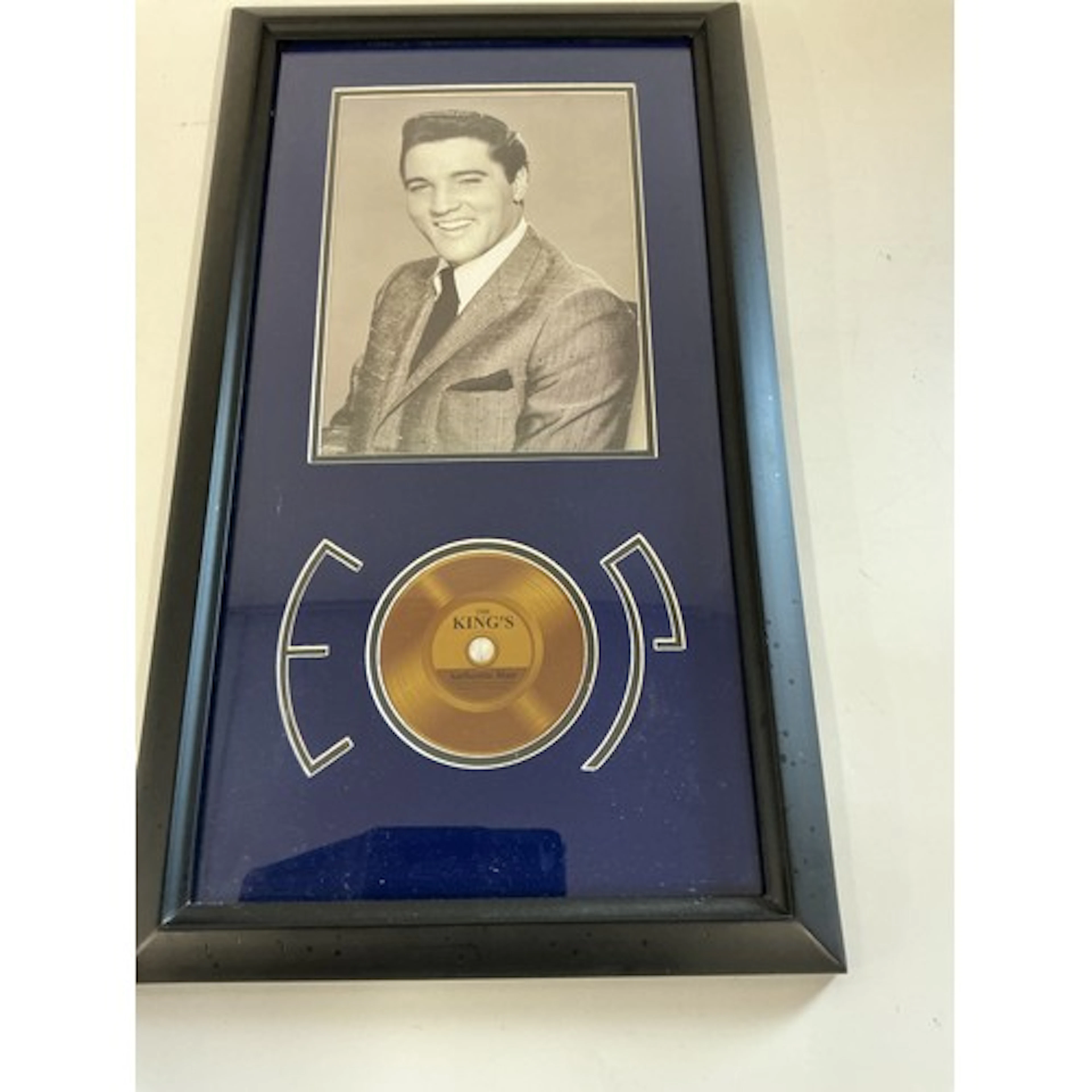 A framed and glazed Elvis Presley presentation containing a ...