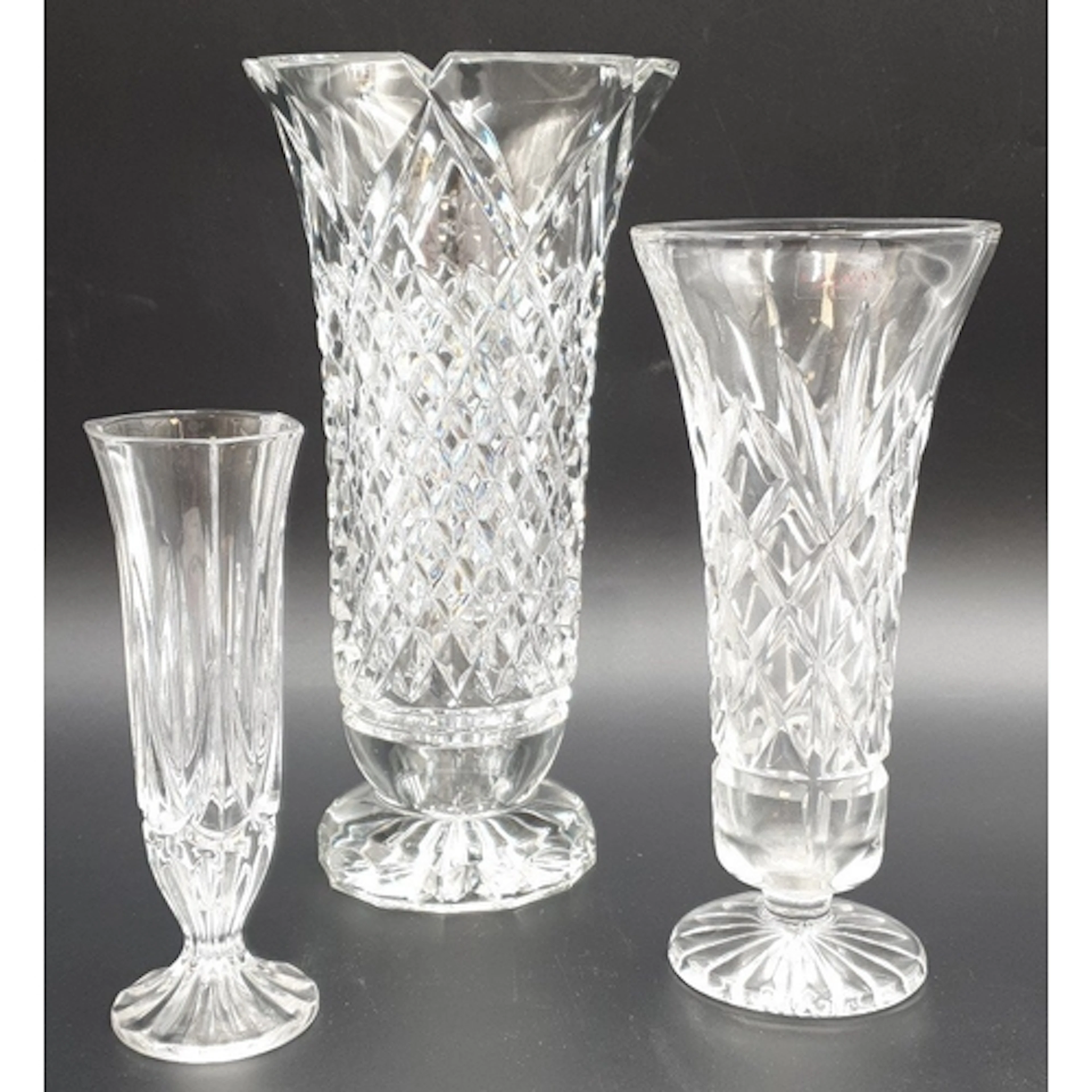 Lot of three cut-crystal footed vases of differing forms and...