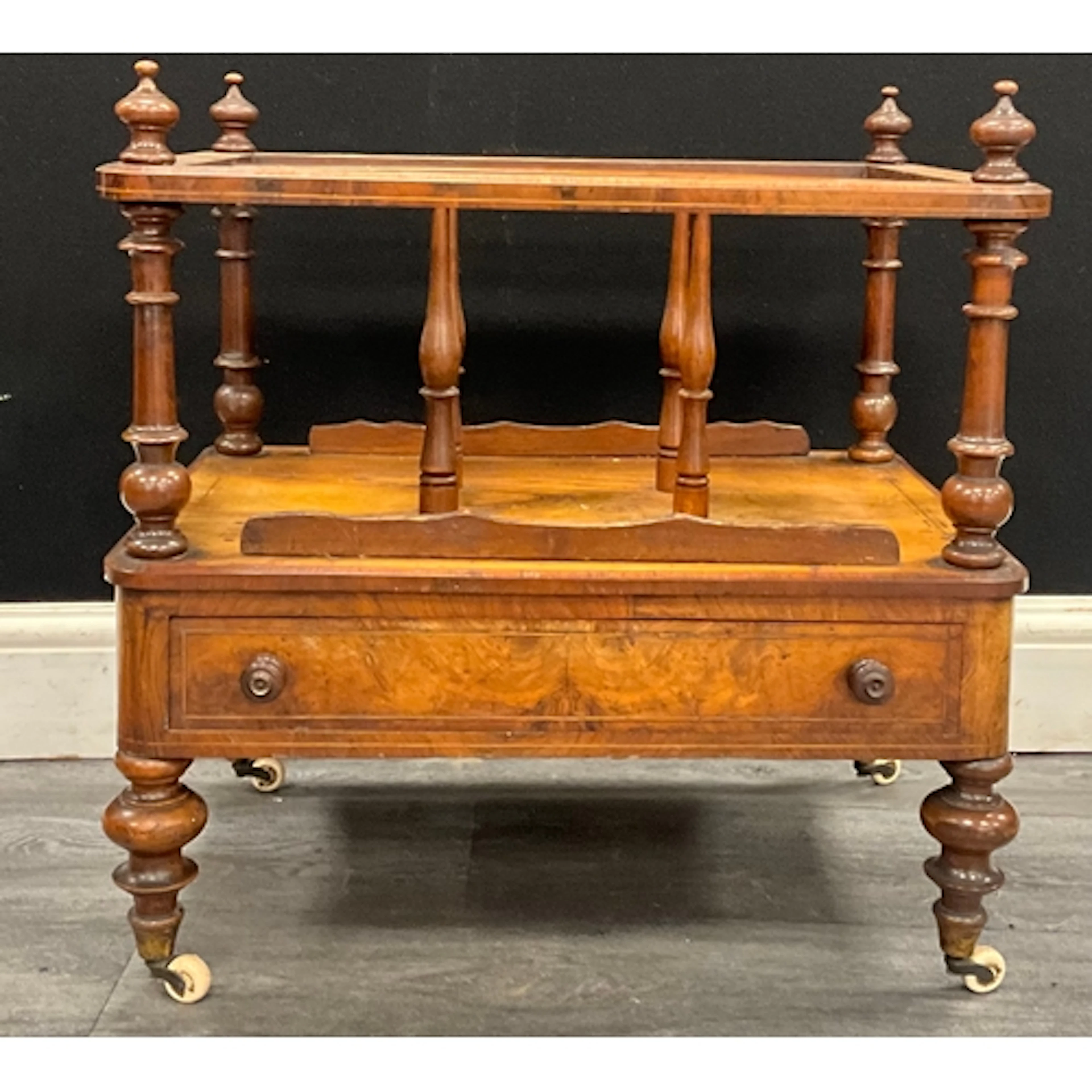 A Victorian Walnut Canterbury, four turned urn-shaped finial...
