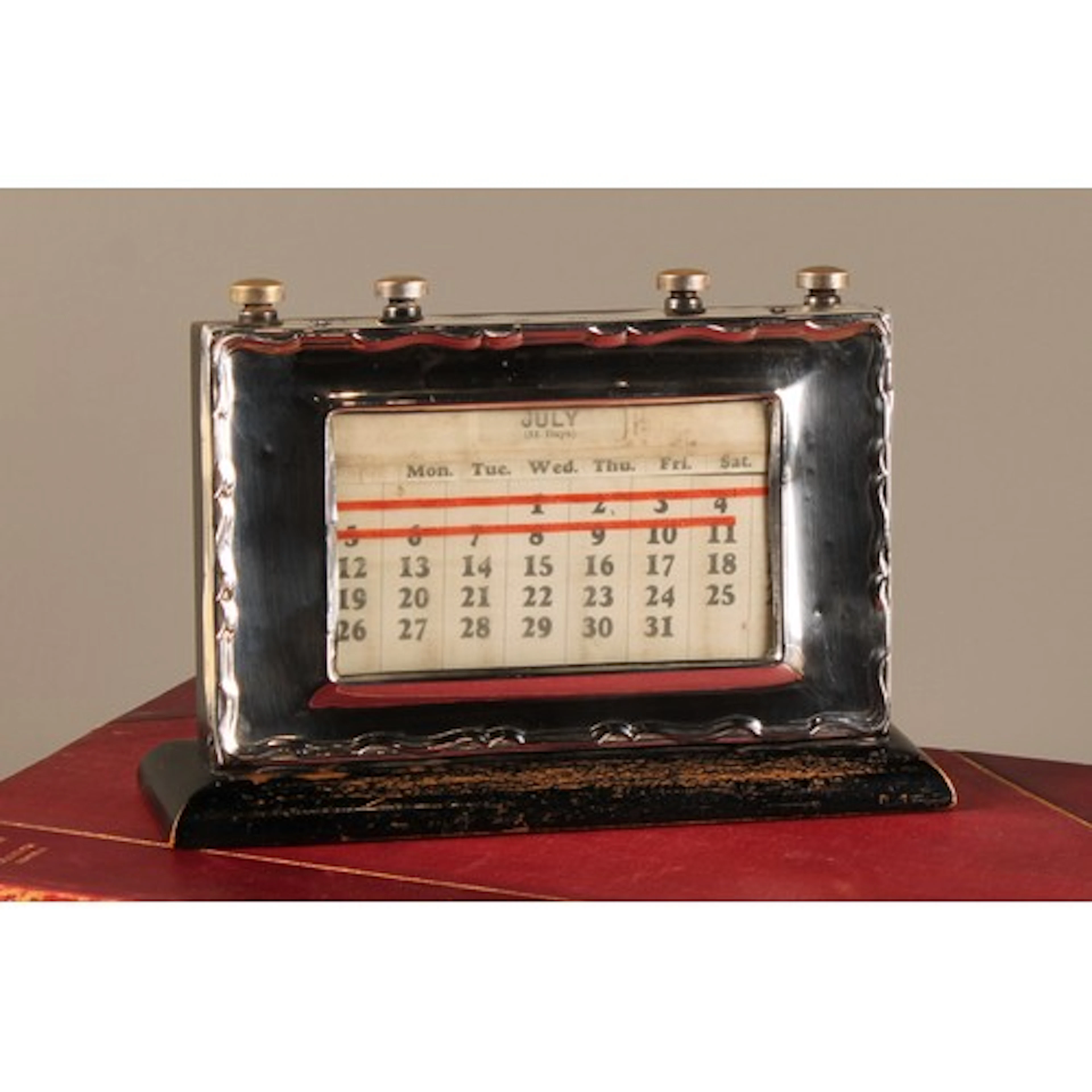 A George V silver rectangular desk calendar, Chippendale pie...