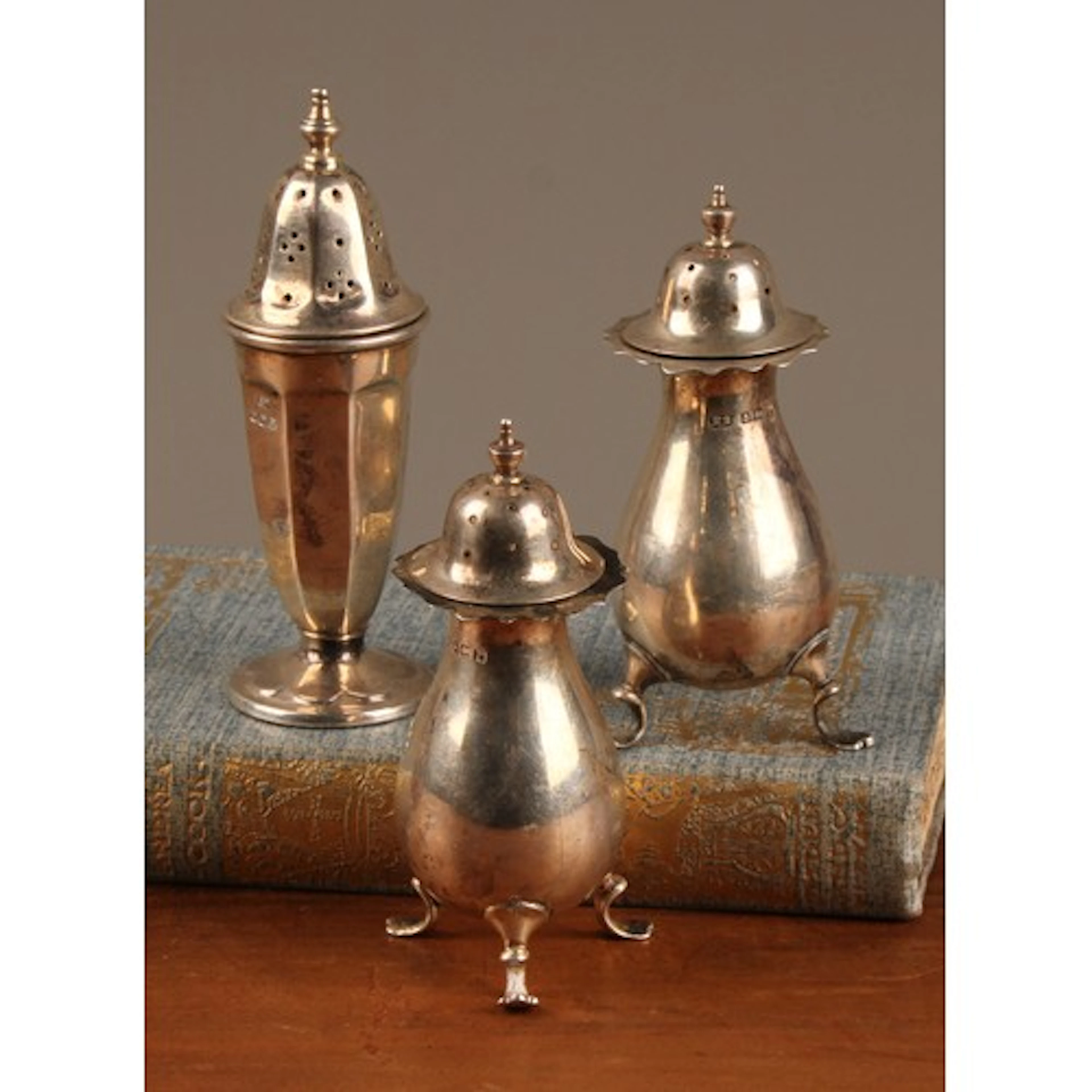 A pair of George V silver pepperettes, retailed by Harrods L...