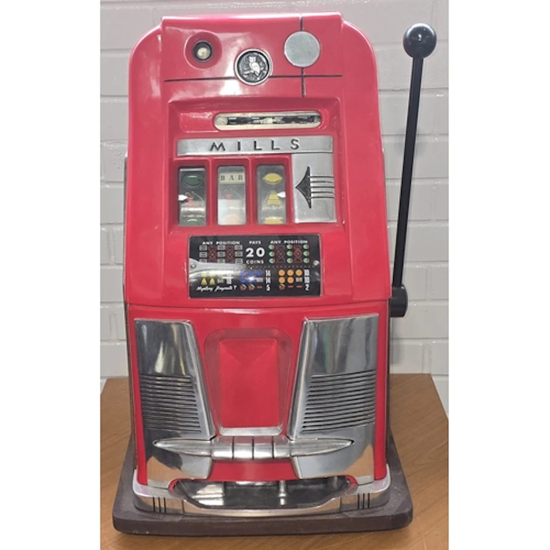 A vintage mid 20th century red Mills high top slot machine w...