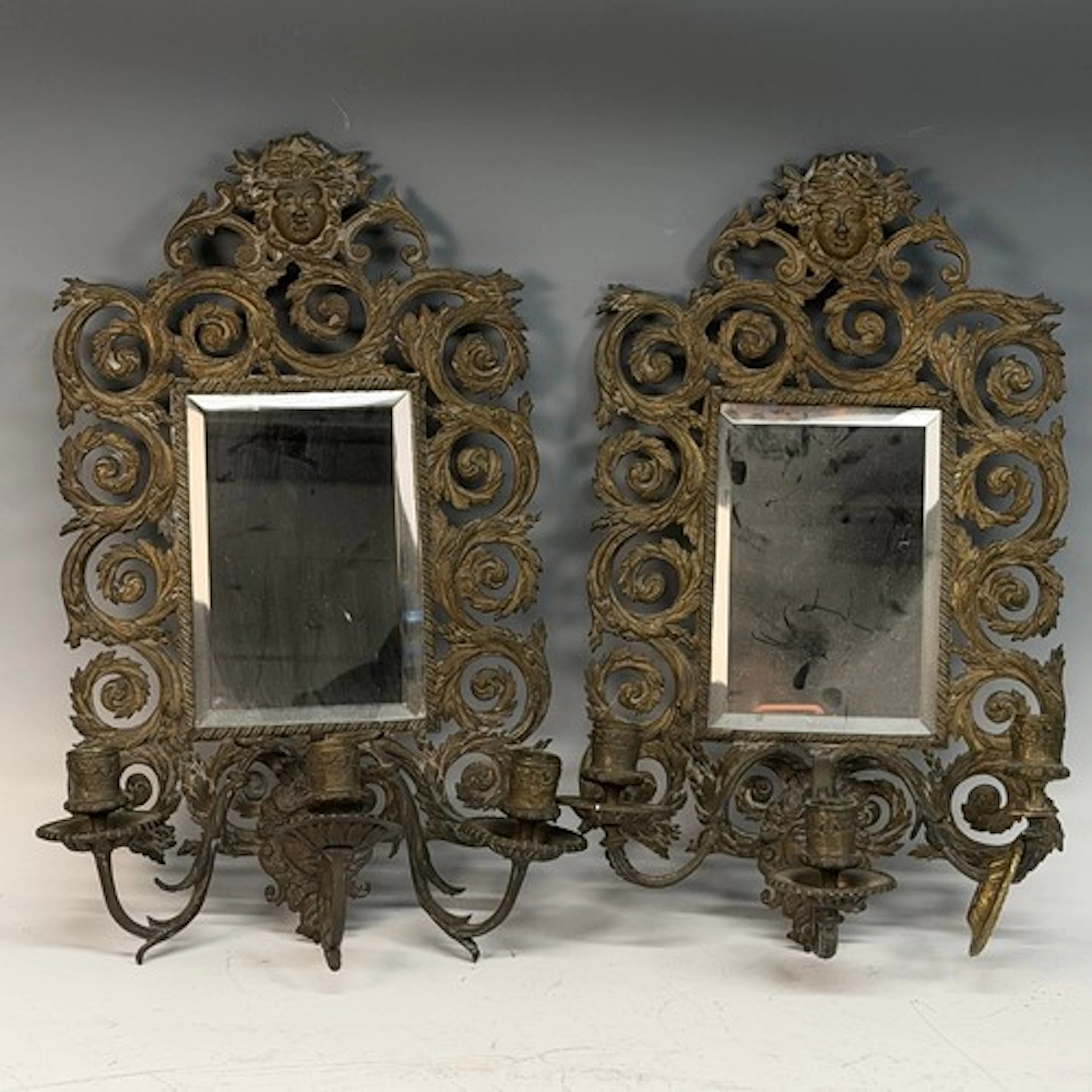 A pair of antique French gilt cast metal three-light wall Mi...