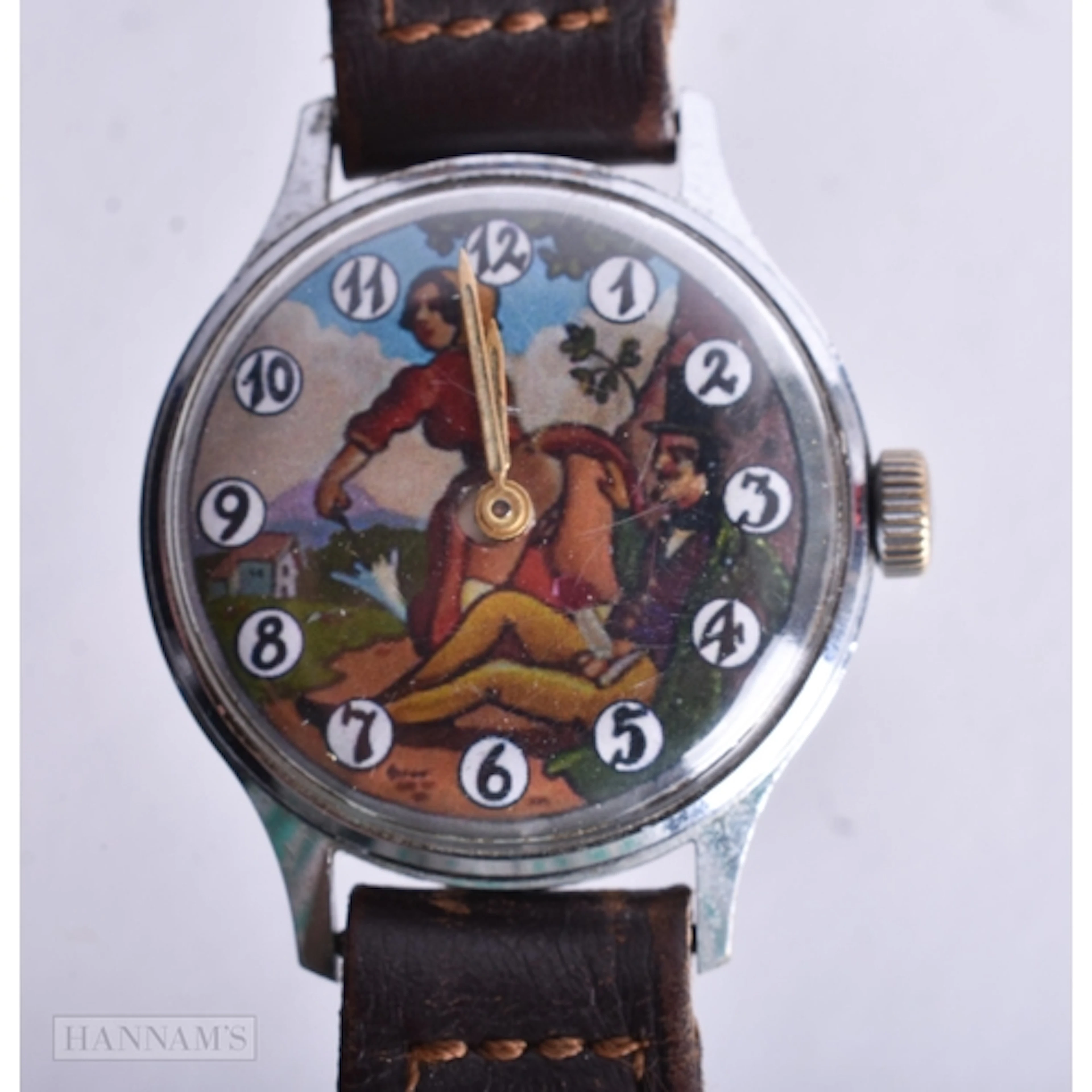 An Erotic Watch with Leather Strap. Working. 3.5cm incl cro...