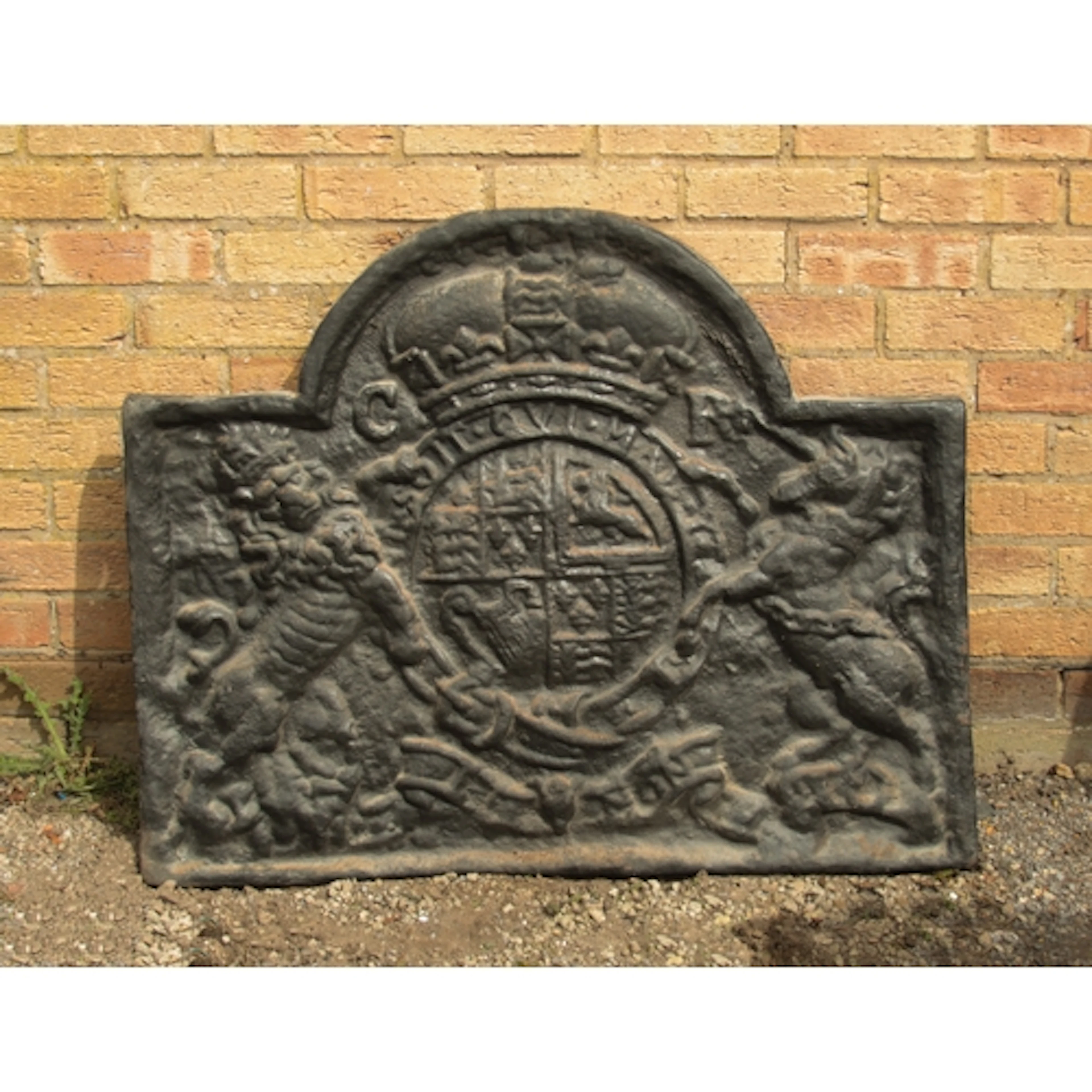 A large cast iron fire-back in the Carolean style - the brok...