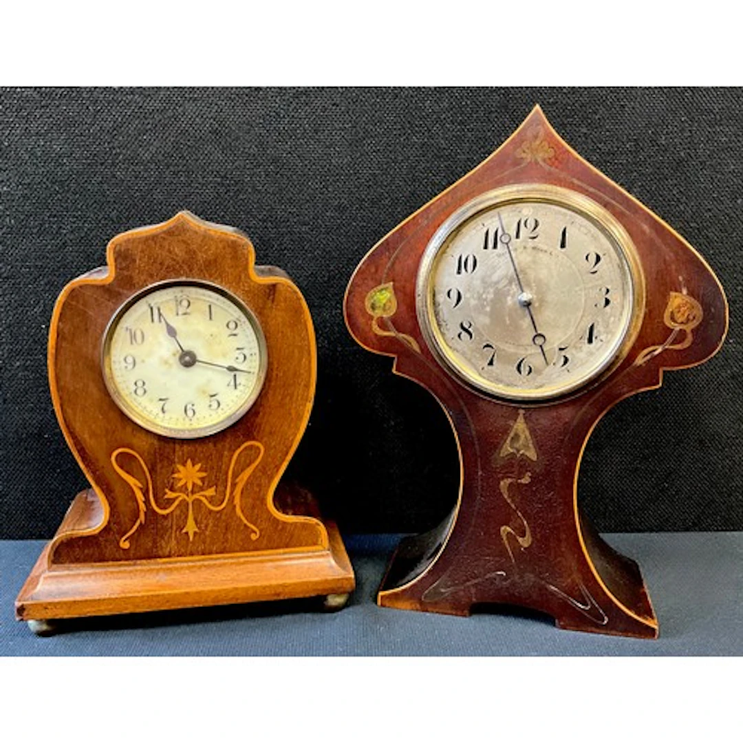 An Art Nouveau balloon clock, silver red dial, Arabic numera...