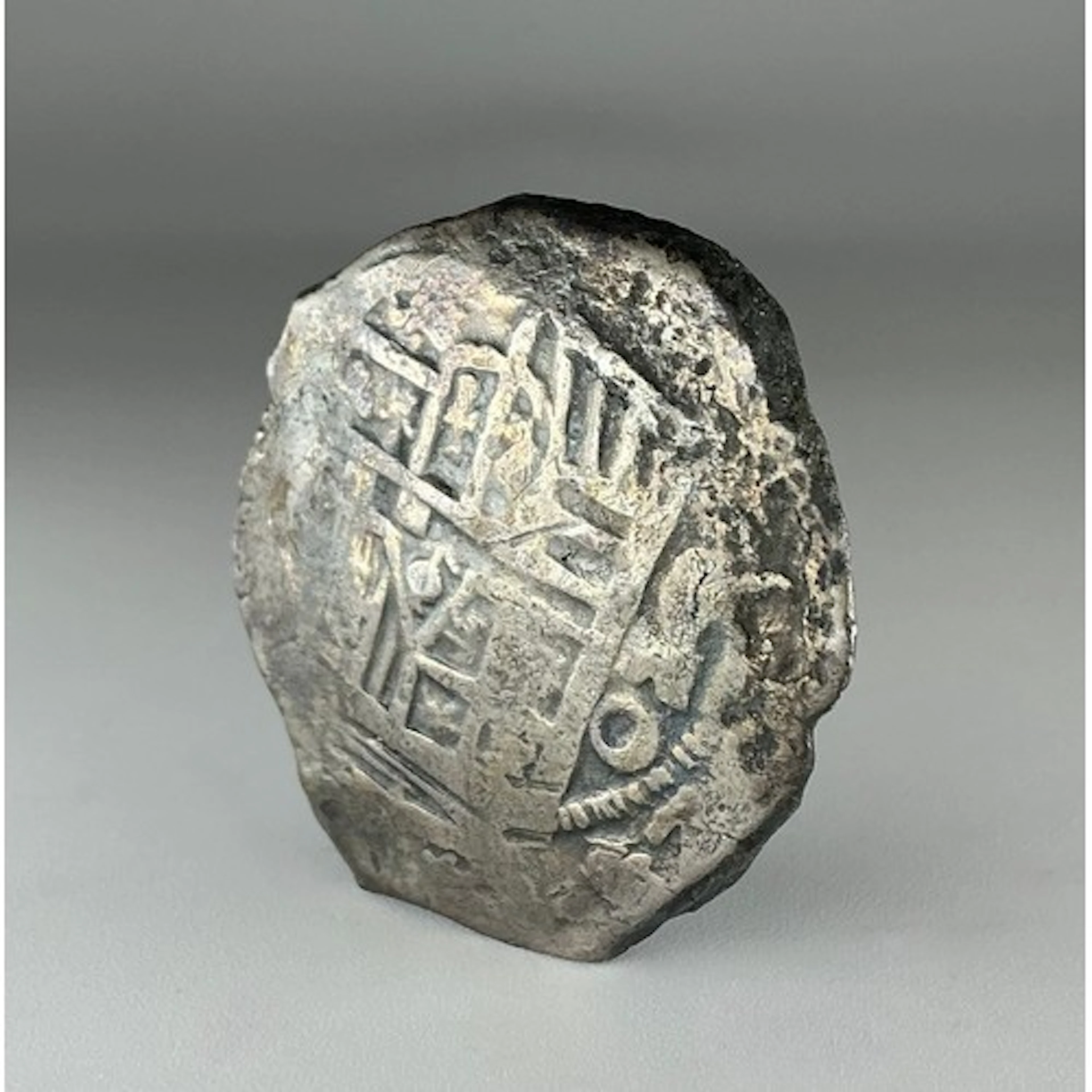 A 17th century piece of eight or eight Reales, within a Spin...