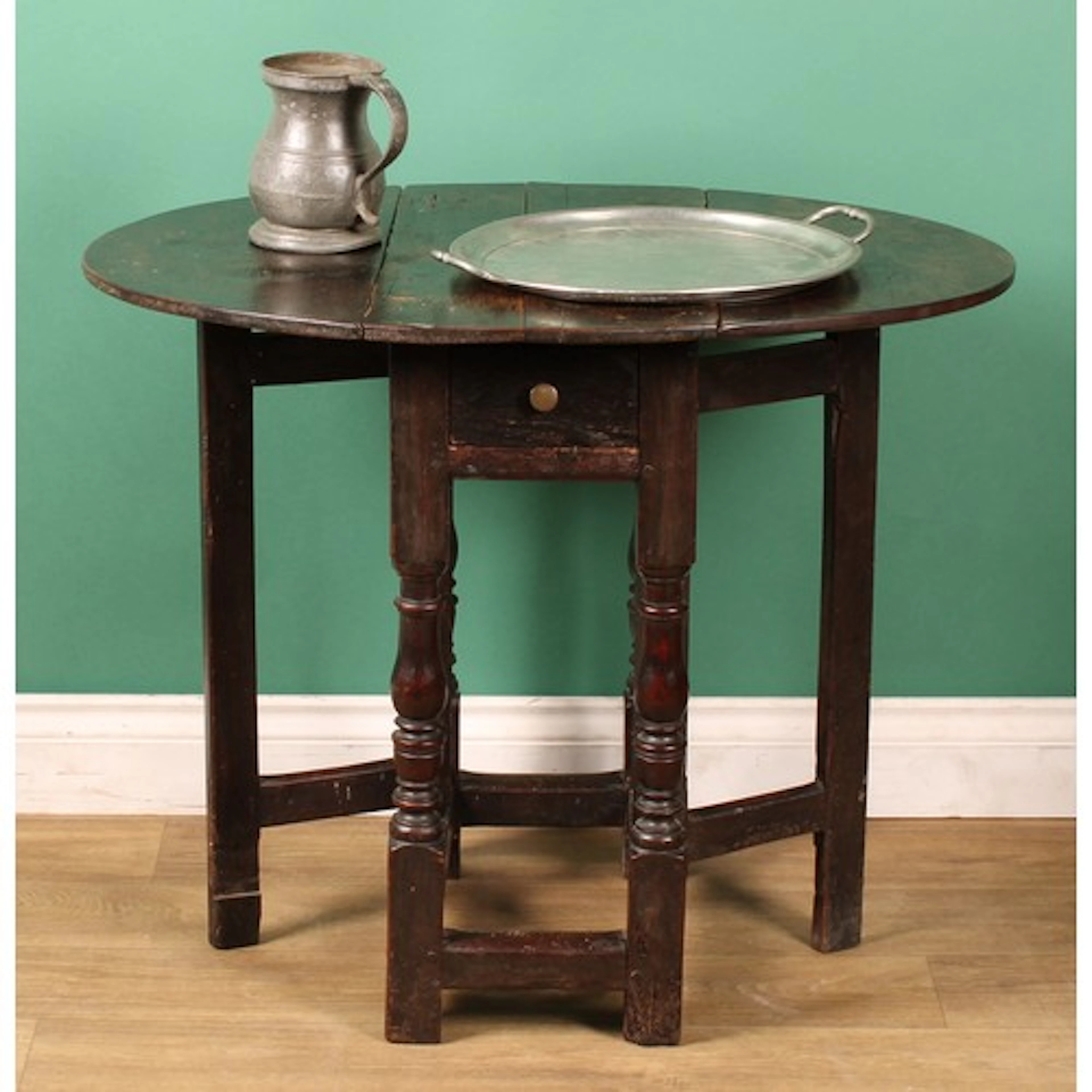 An early 18th century vernacular oak and fruitwood gateleg t...