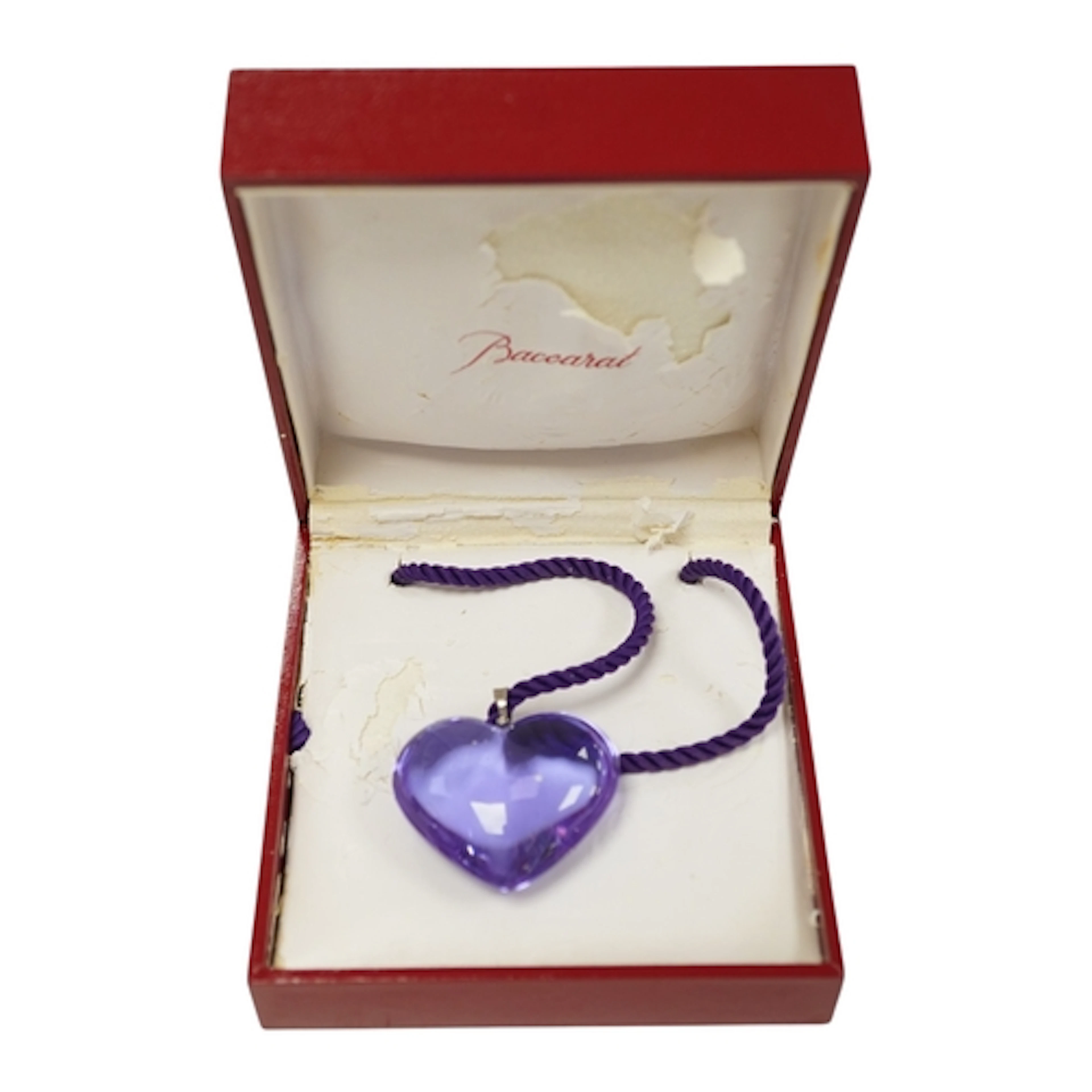 Baccarat, a violet glass heart-shaped pendant, on a violet c...