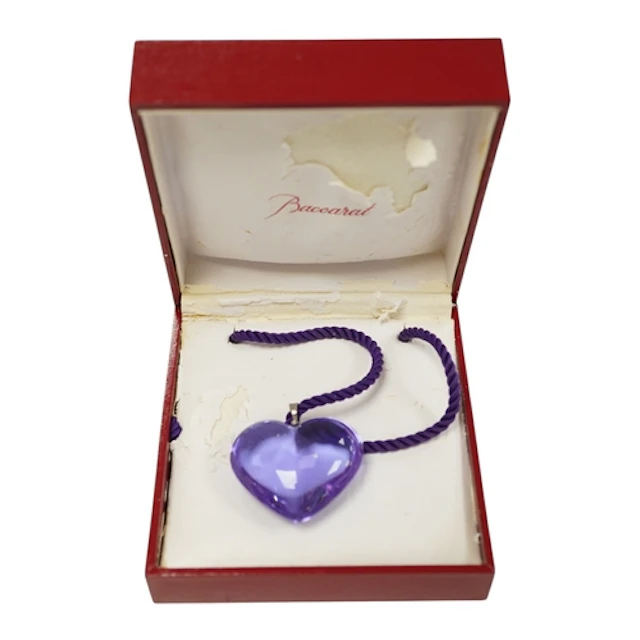 Baccarat, a violet glass heart-shaped pendant, on a violet c...