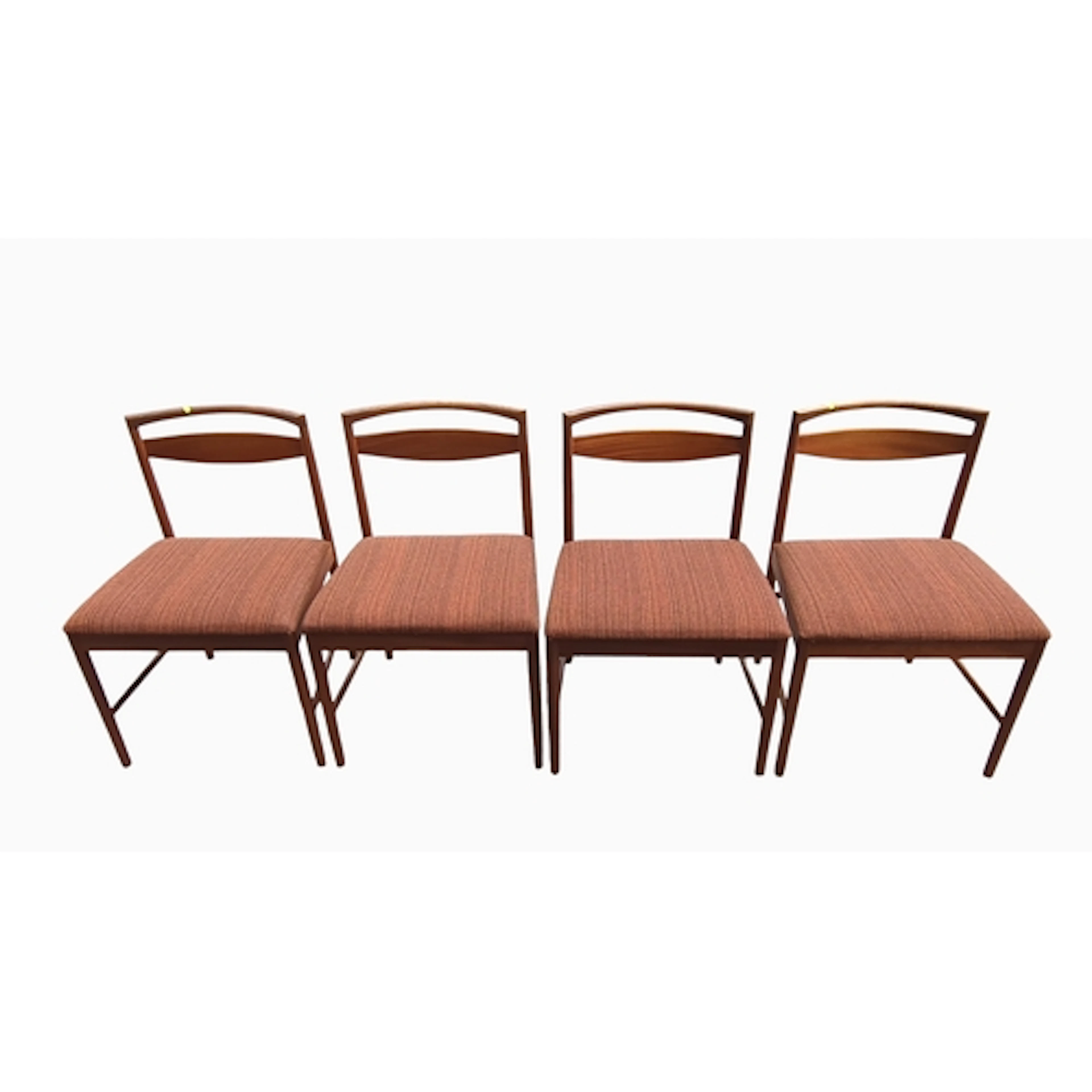 A set of four mid-century teak dining chairs, each with an a...