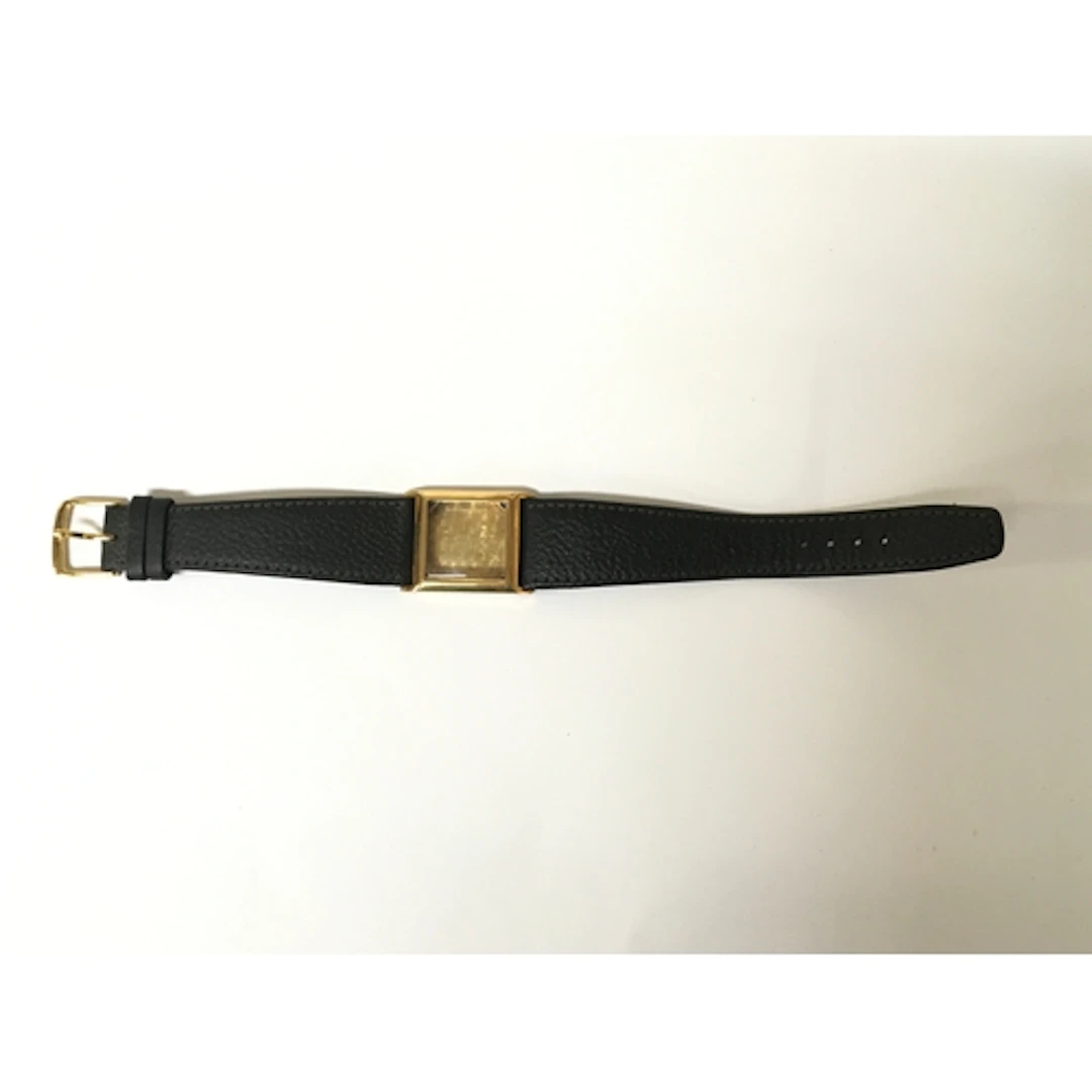 A 14k gold vintage Omega watch case of square shape on leath...