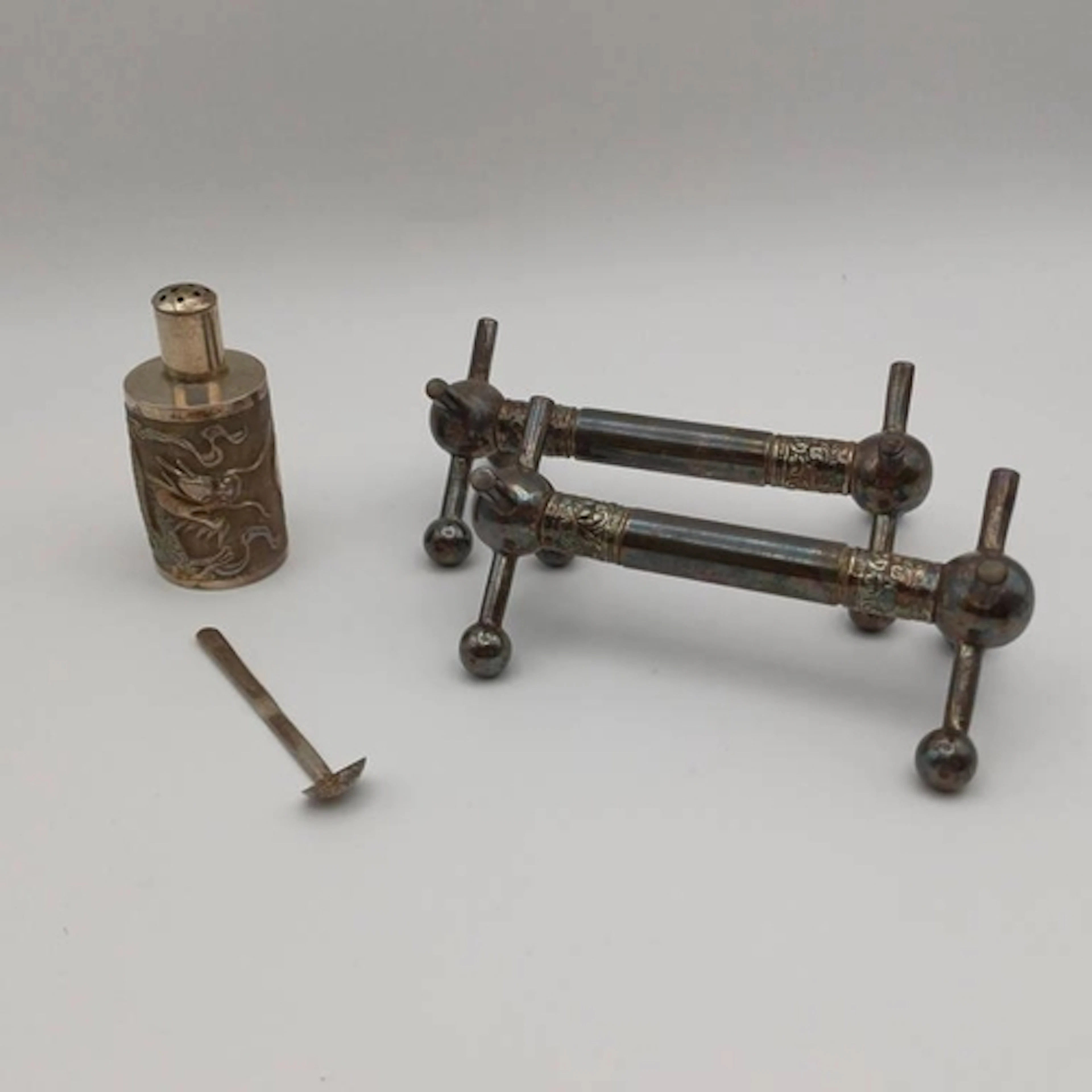 A CHINESE SILVER PEPPER WITH EMBOSSED DRAGON DECORATION BY K...