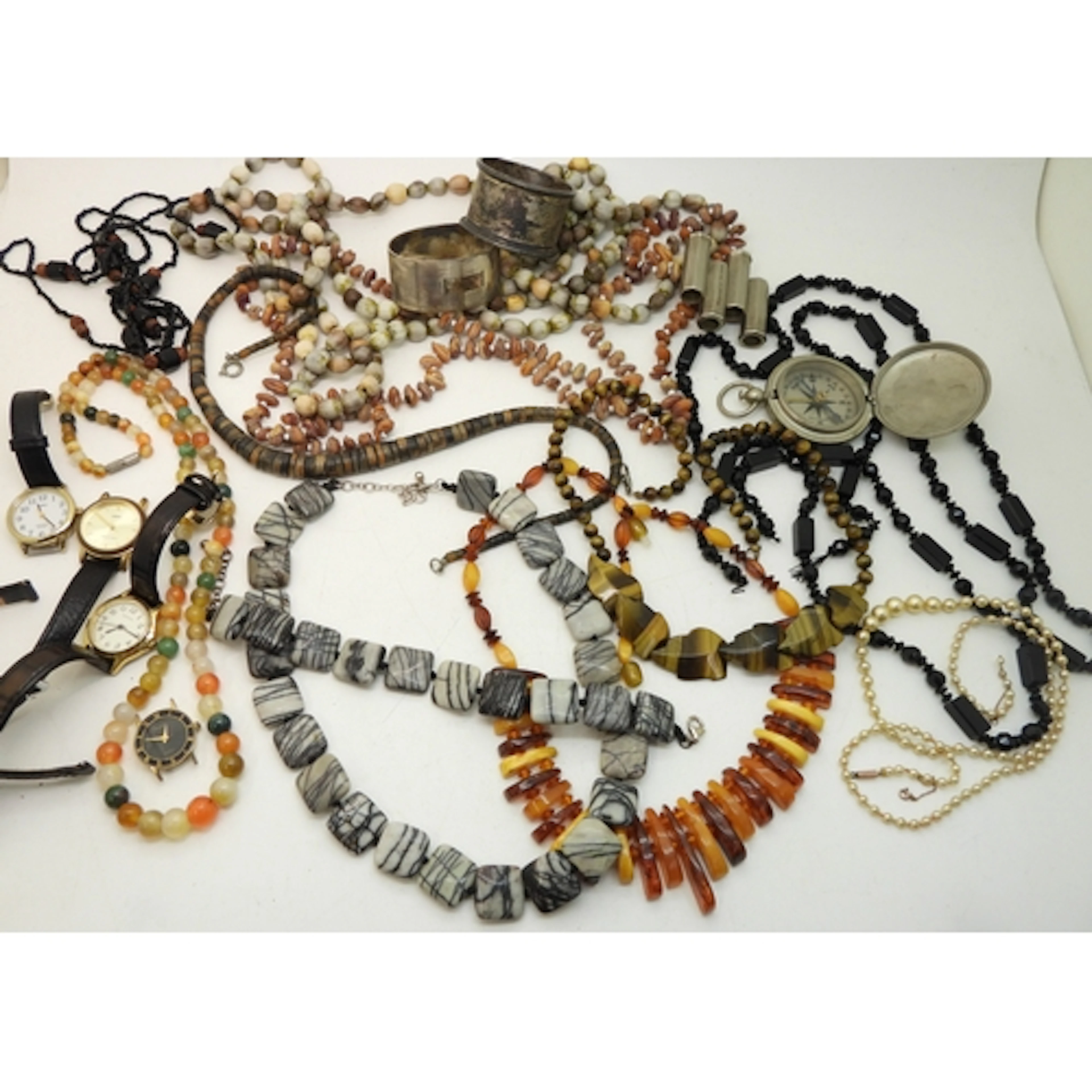 A string of tiger's eye beads carved as leaves, a string of ...