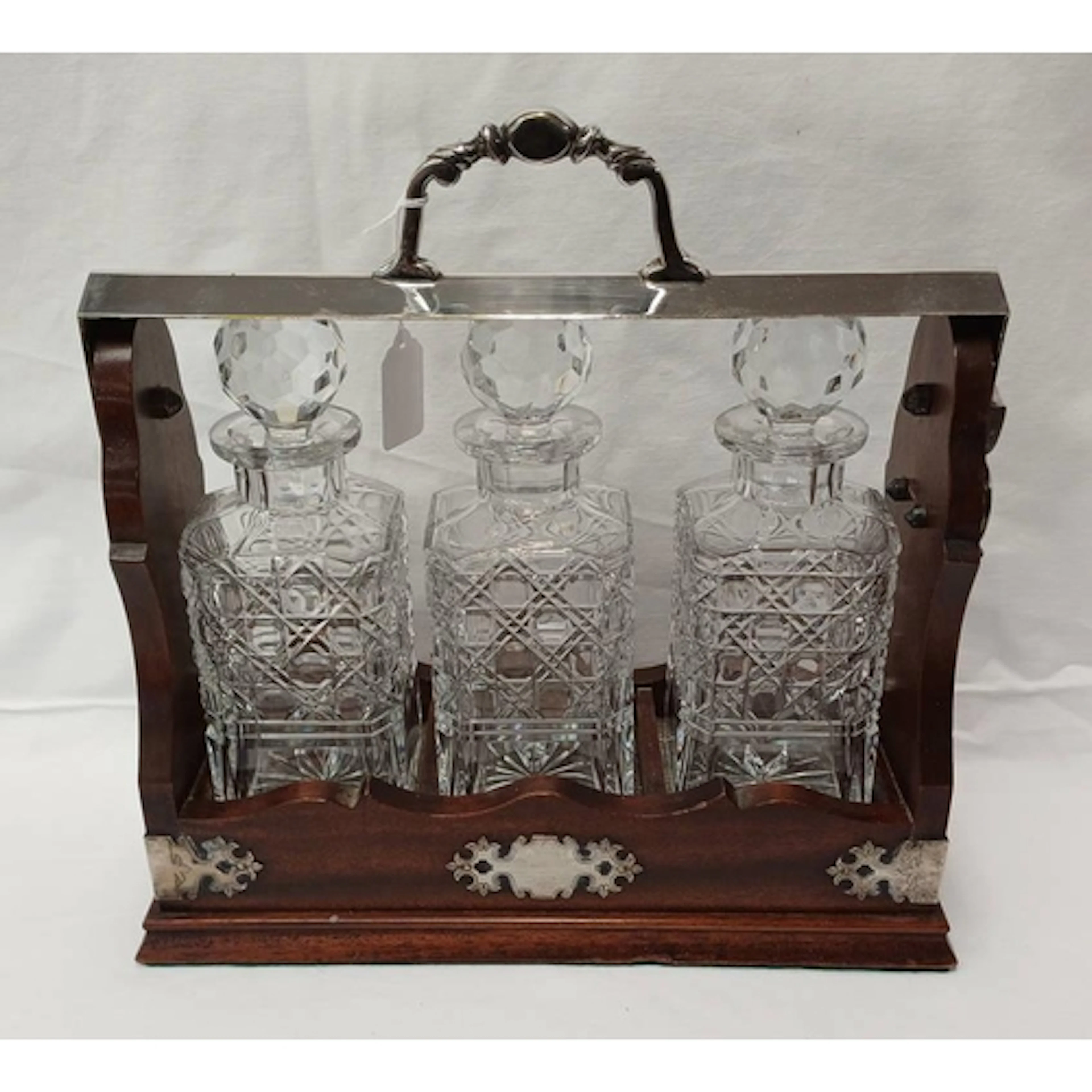 A MAHOGANY TANTALUS WITH SILVER PLATED MOUNTS & 3 CUT GLASS ...