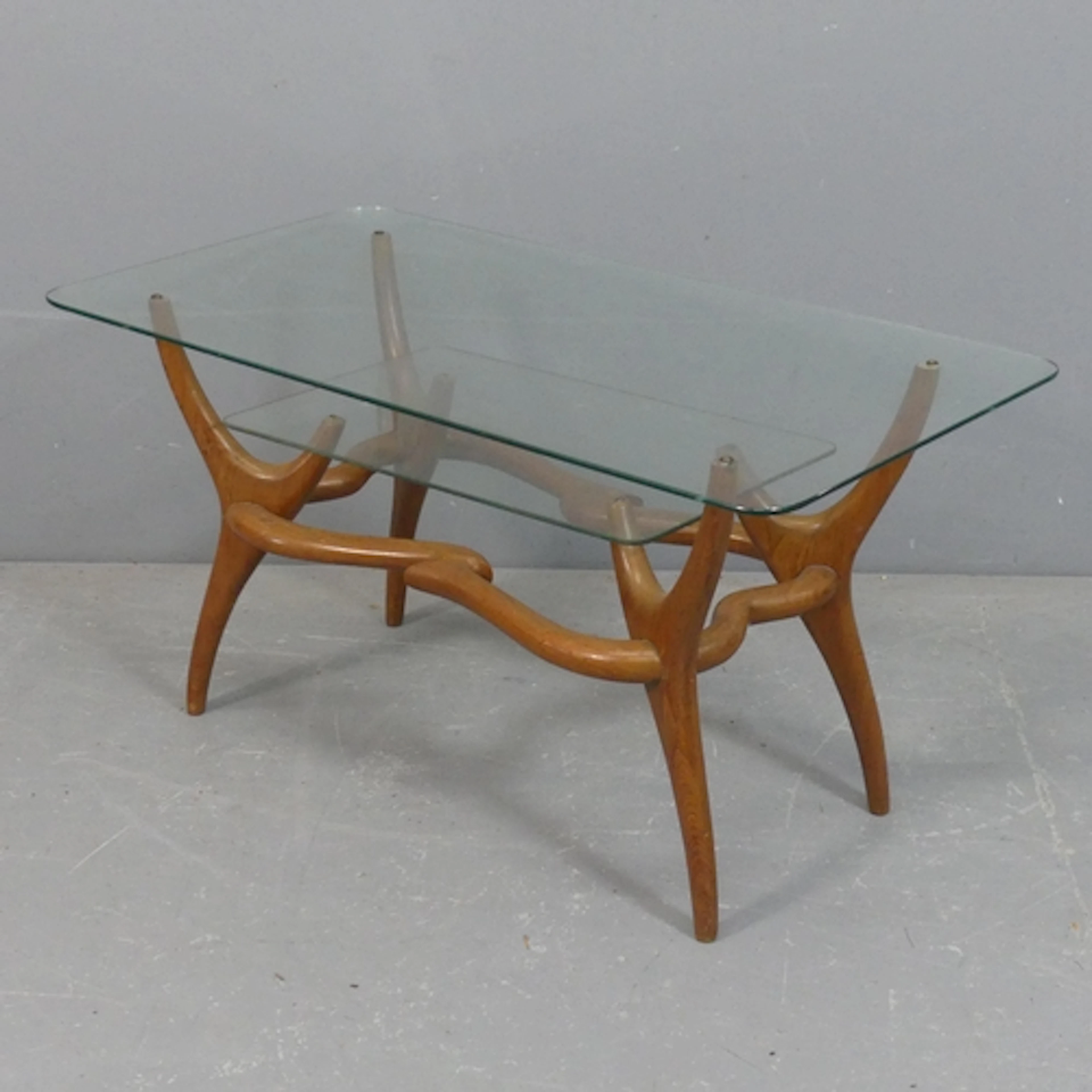 A mid-century Italian coffee table in the manner of Gio Pont...
