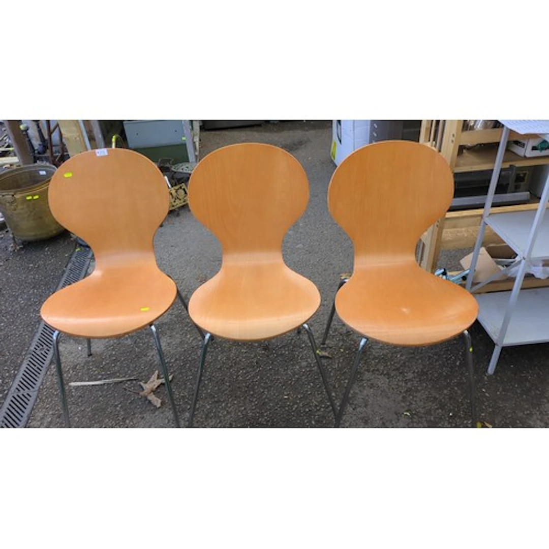 Three contemporary dining chairs, each with a moulded plywoo...
