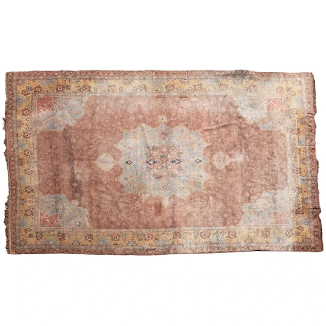 A Turkish carpet, the plum field with a central pastel blue ...