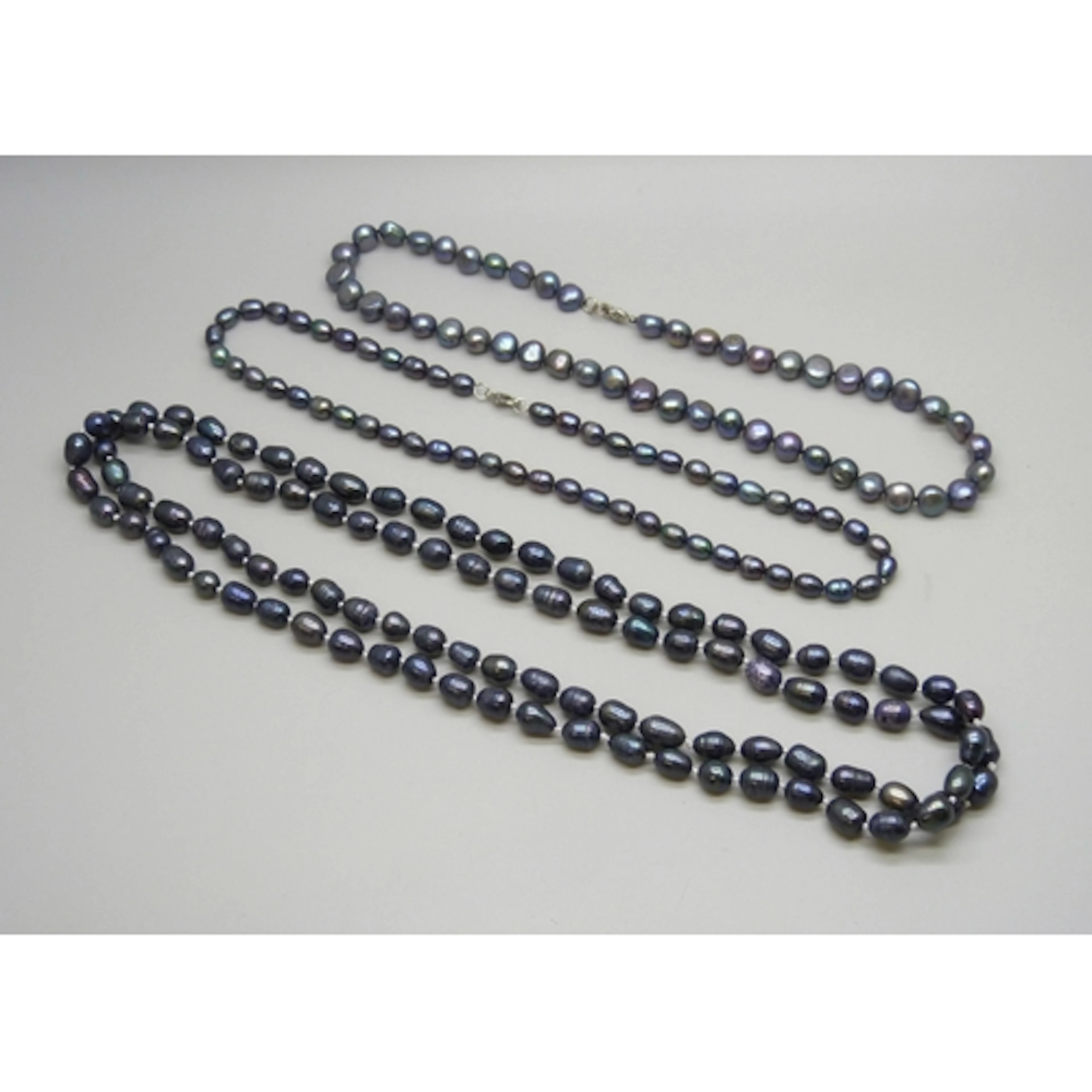 Three black pearl necklaces including an opera length exampl...