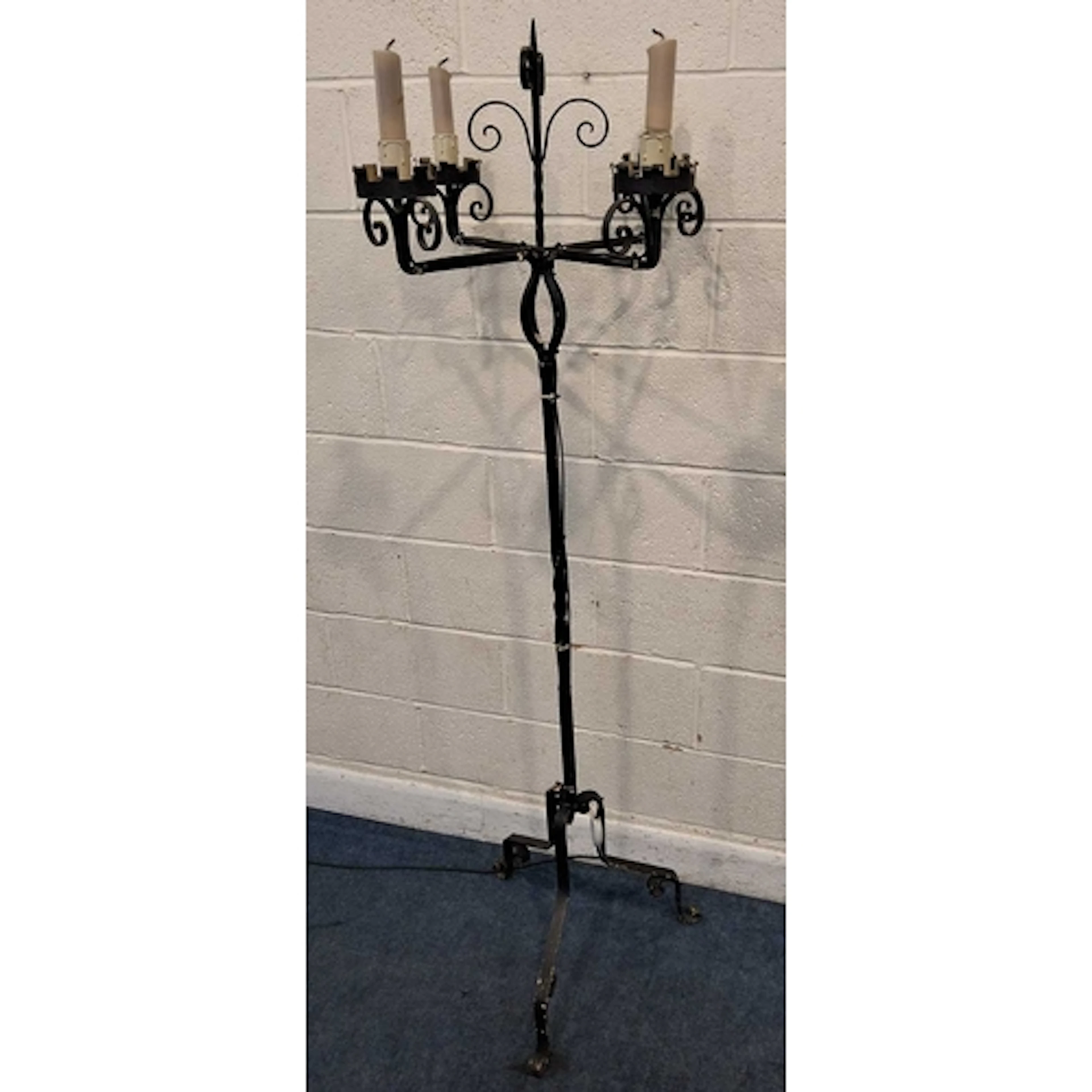 A WROUGHT IRON ECCLESIASTICAL STYLE STANDARD LAMP, in the fo...