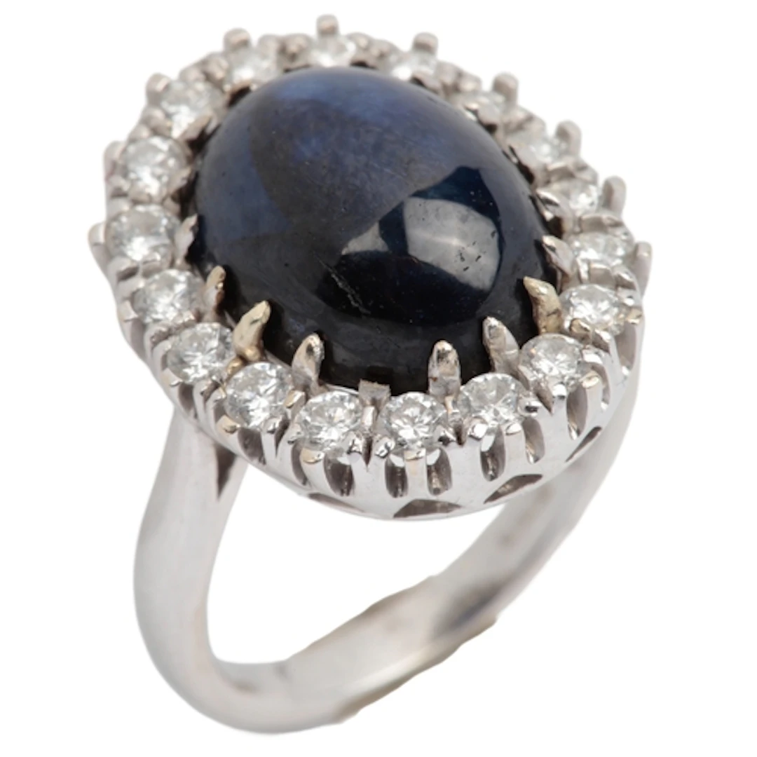 A treated sapphire and diamond ring, claw-set with a colour-...