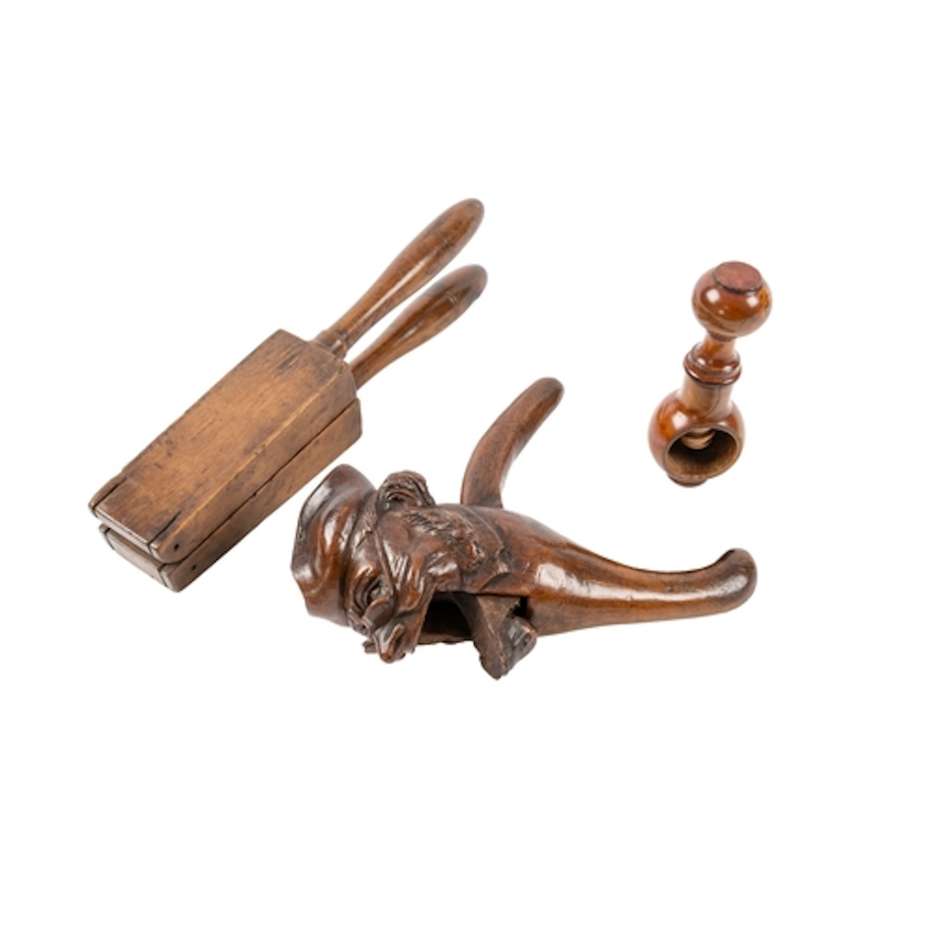 A carved and stained treen nutcracker in the form of a caric...