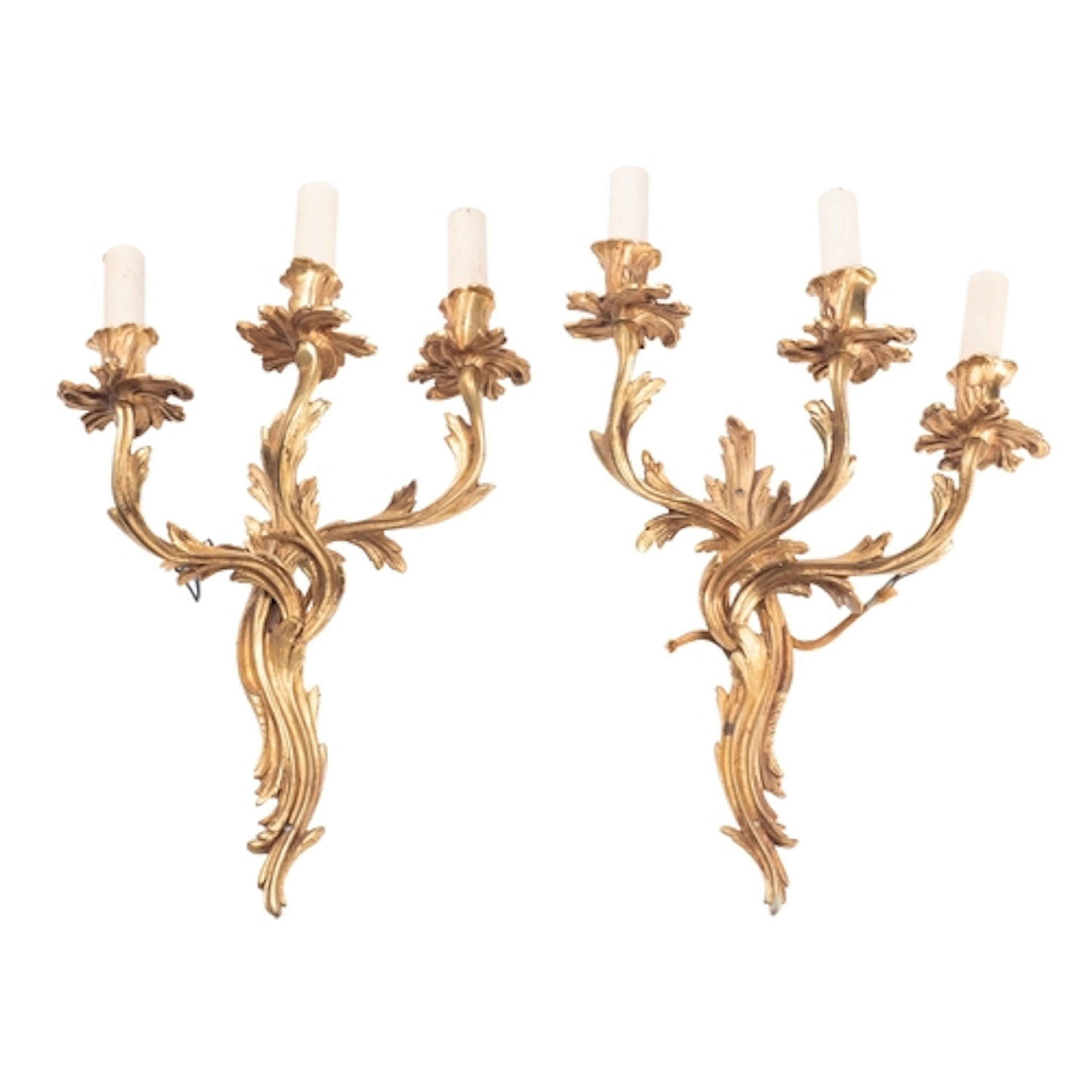 A pair of gilt metal three-light wall appliques in Louis XV ...
