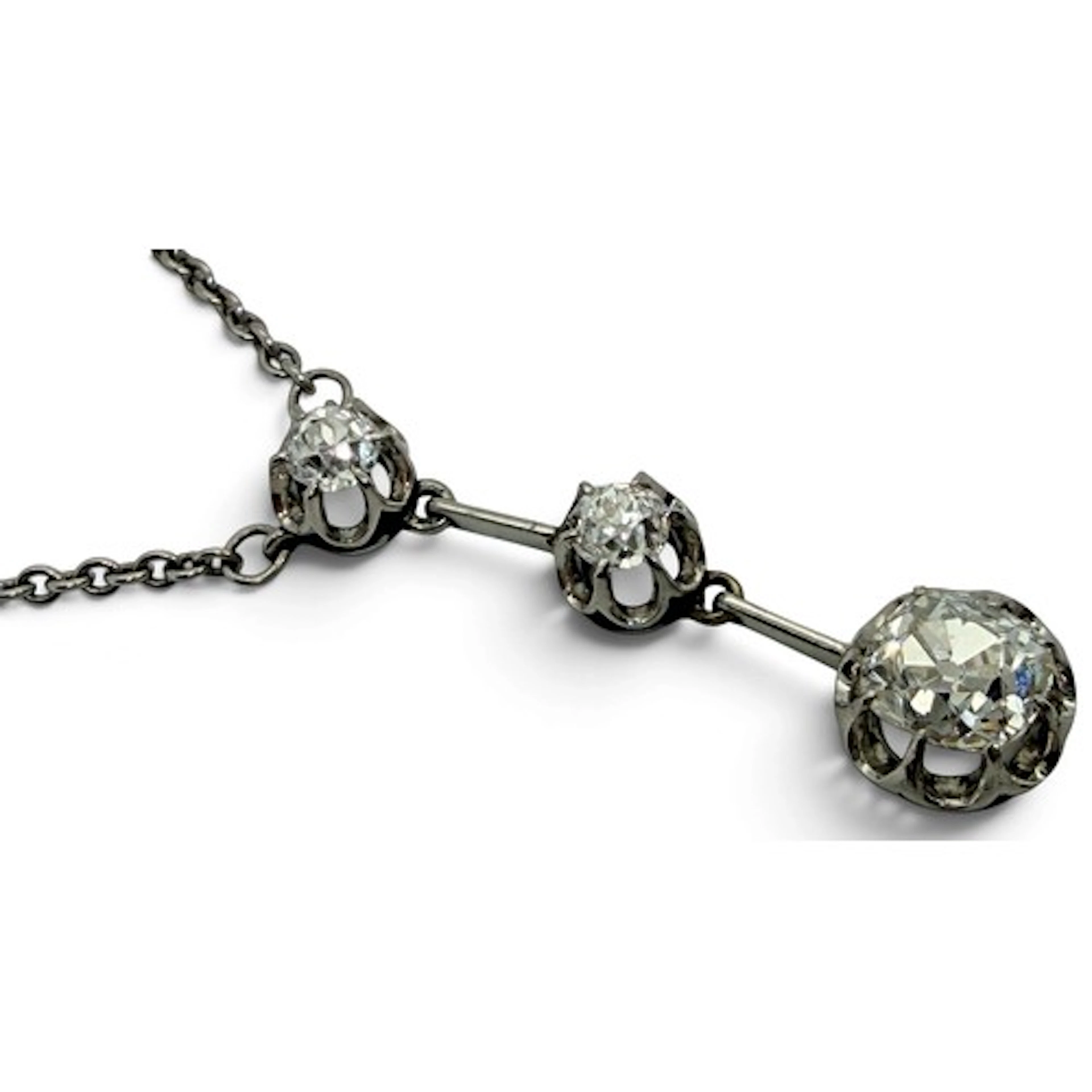 A 20th century three-stone drop pendant necklace, set with t...