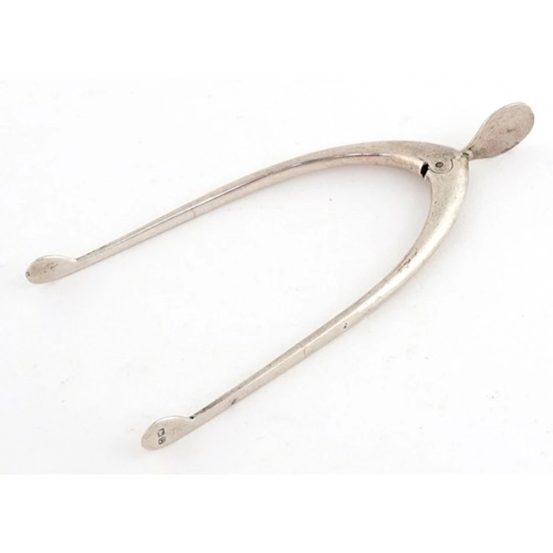 James Swann & Son, pair of George V silver sugar tongs in th...
