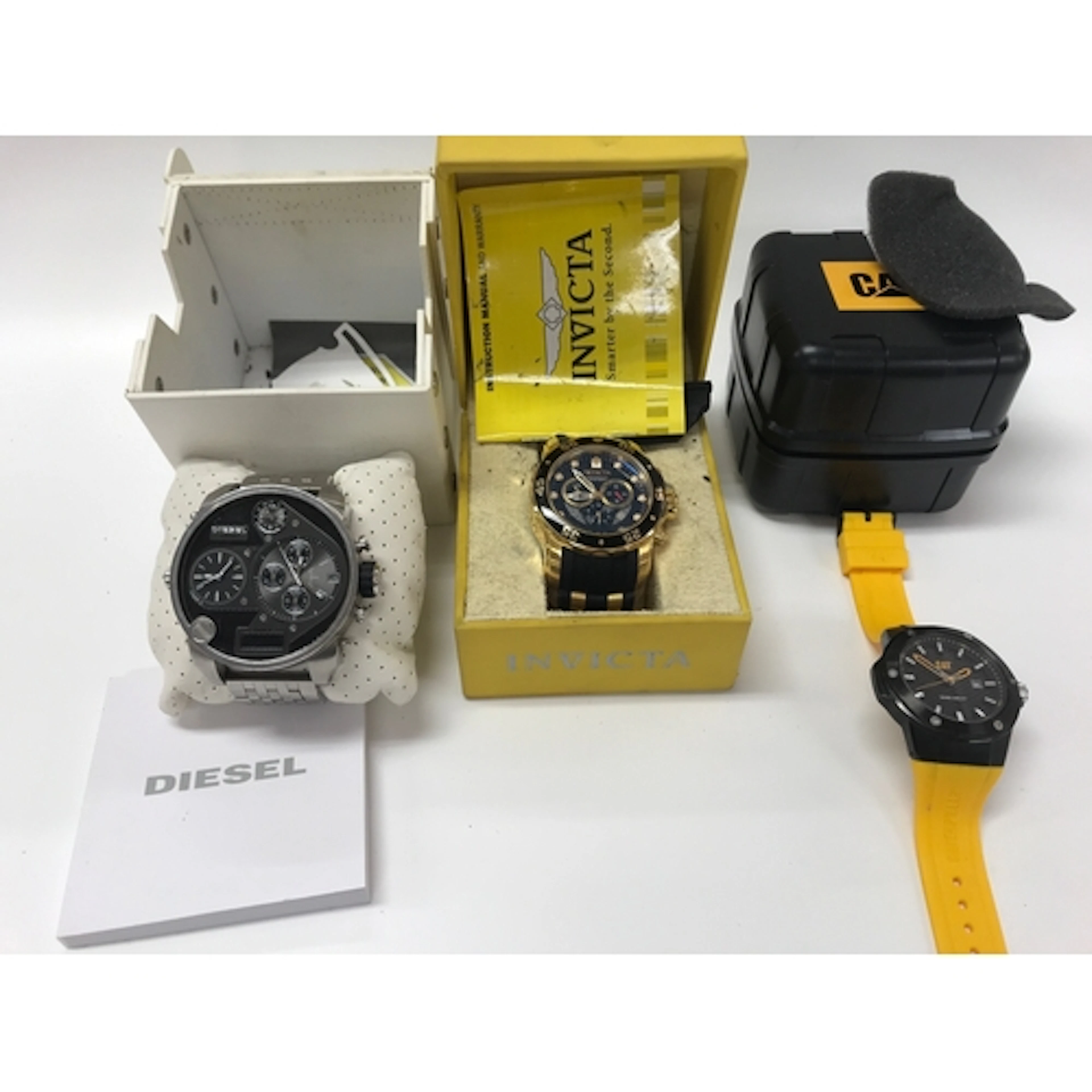 Three fashion watches including Diesel and Cat.