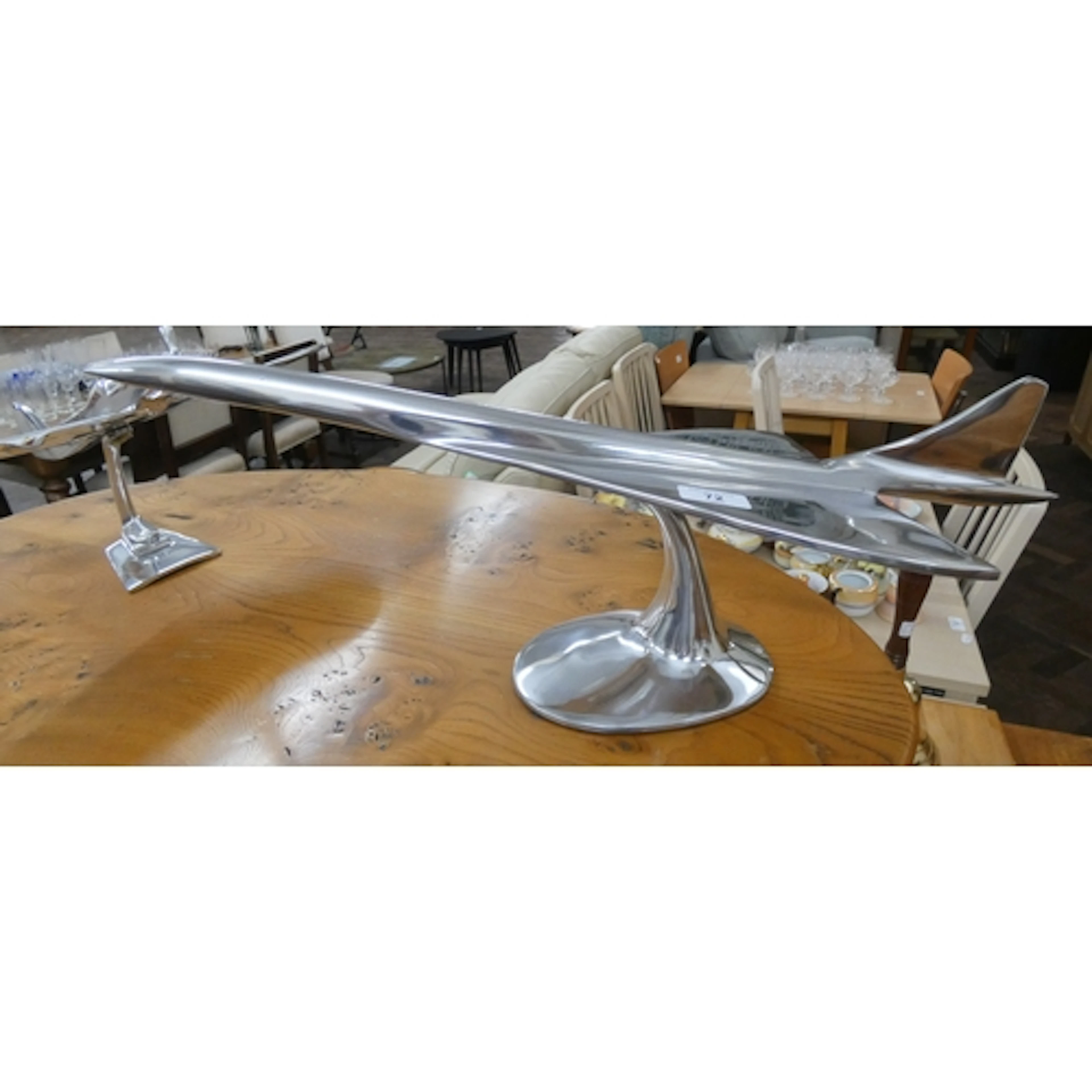 A large polished Concorde ornament