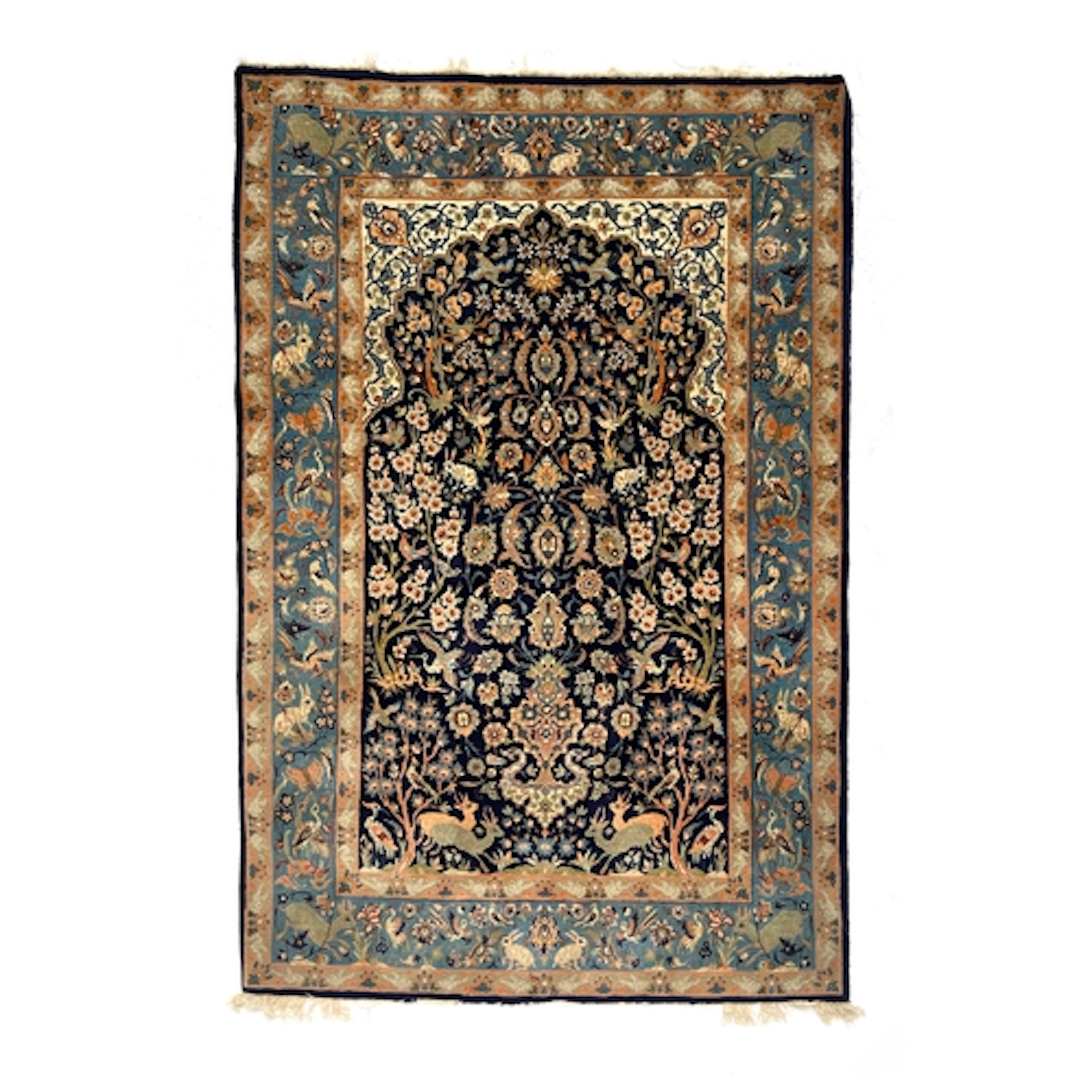 An Isfahan part silk rug, dense floral pattern on a navy blu...