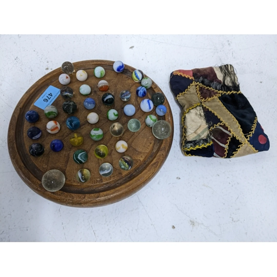 Wooden solitaire board and marbles Location: If there is no ...