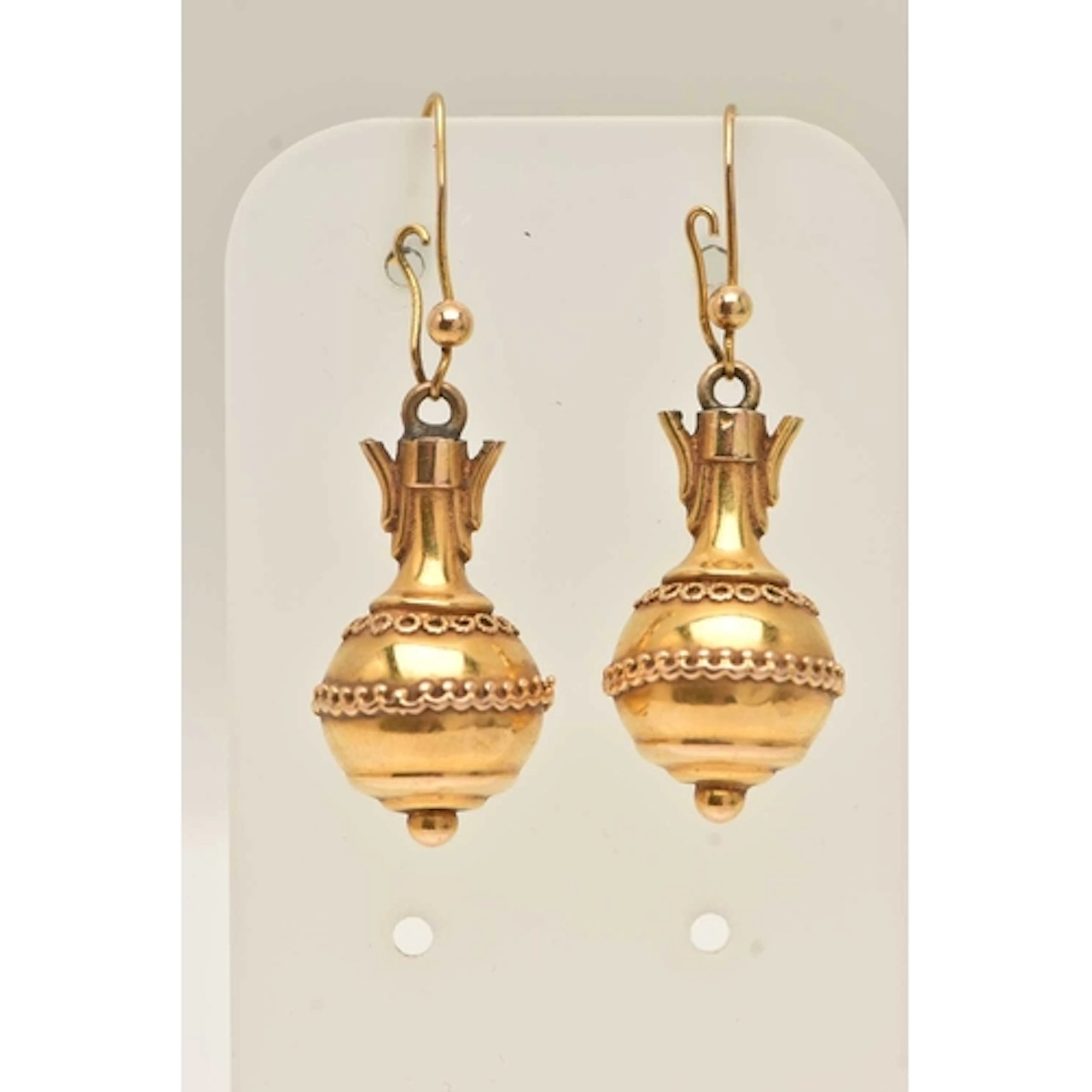 A PAIR OF YELLOW METAL DROP EARRINGS, hollow forms with fish...