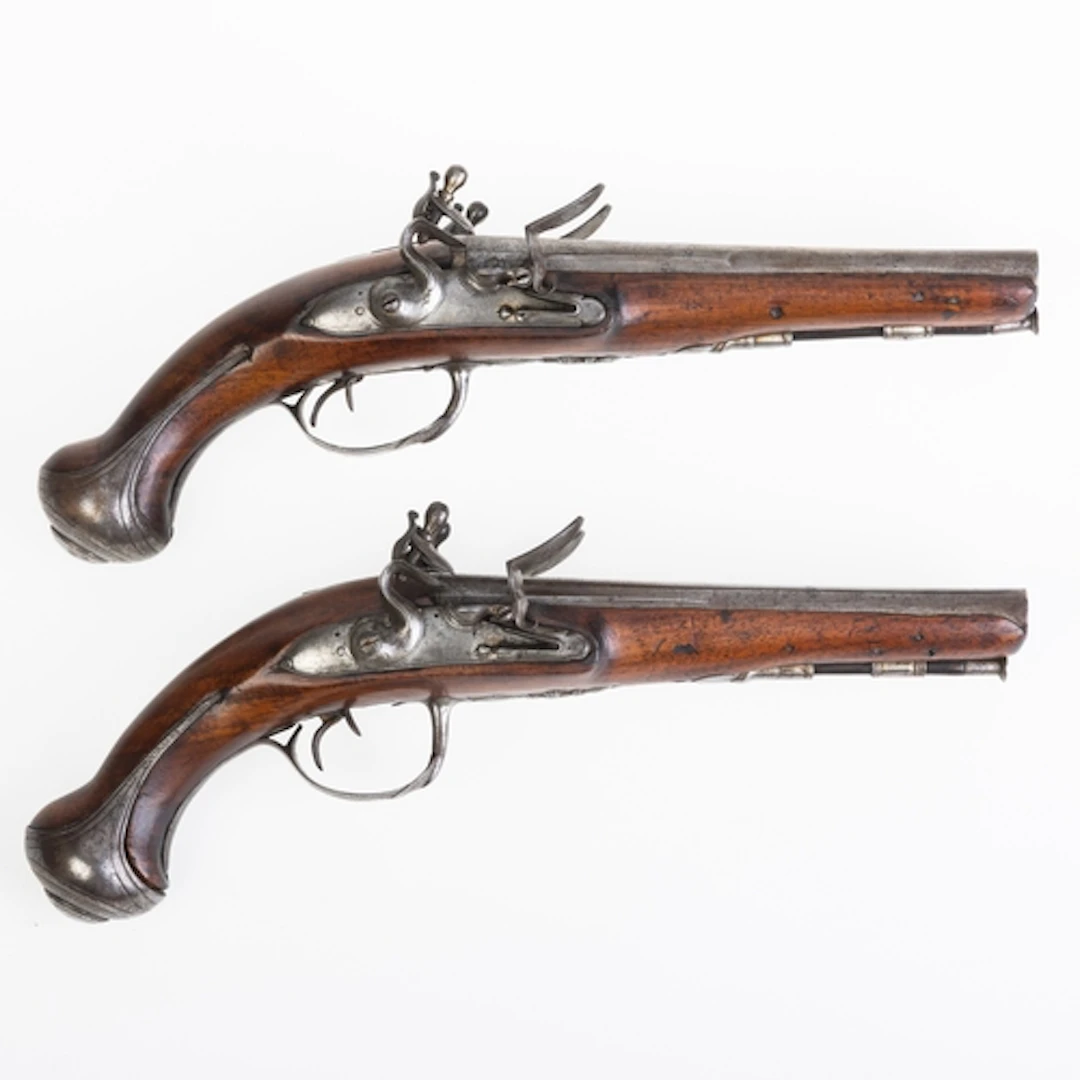 A CASED PAIR OF FRENCH 25 BORE DOUBLE BARRELLED FLINTLOCK. A...