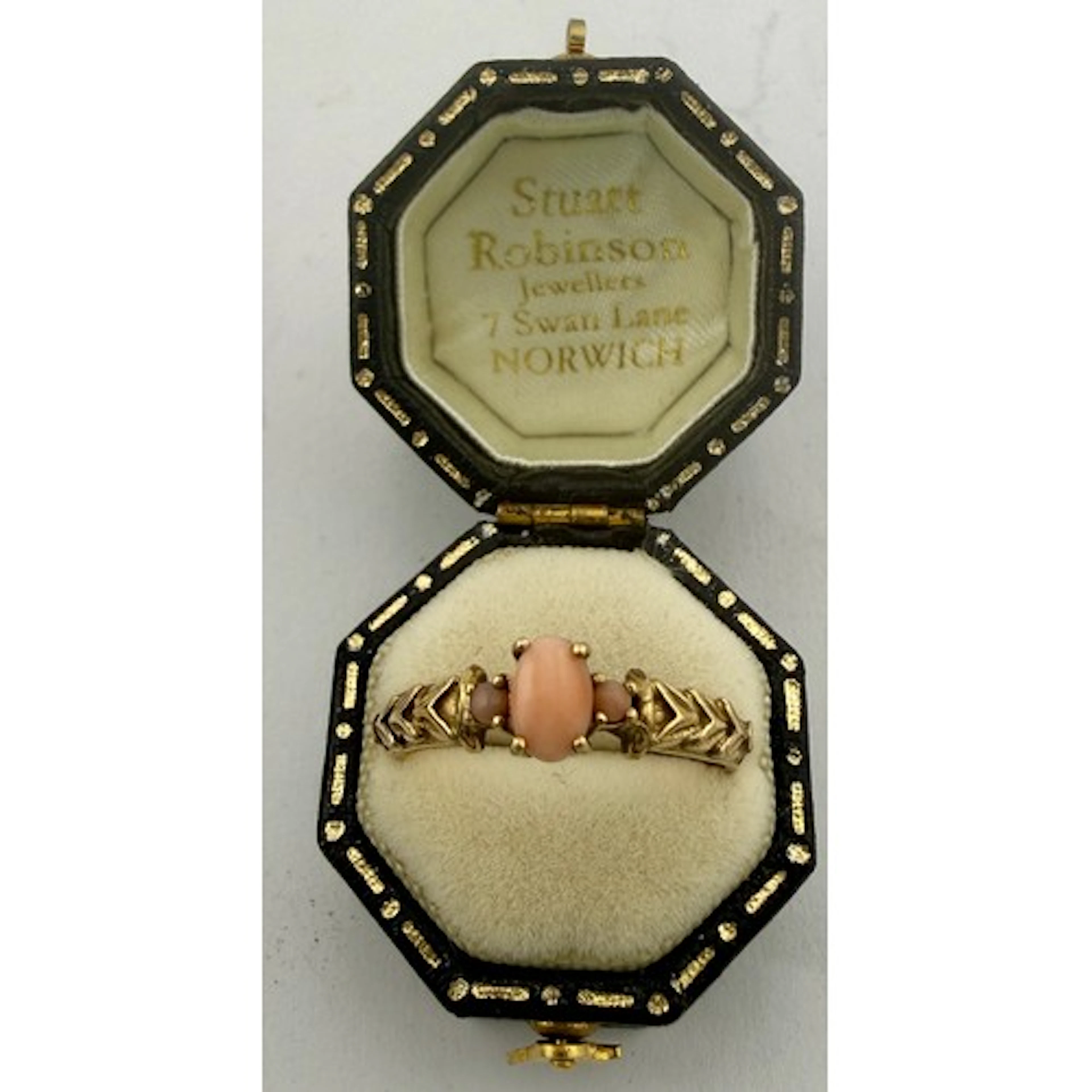 A 9 carat gold ring set with coral. Size Q. Weight 2.5gm.
