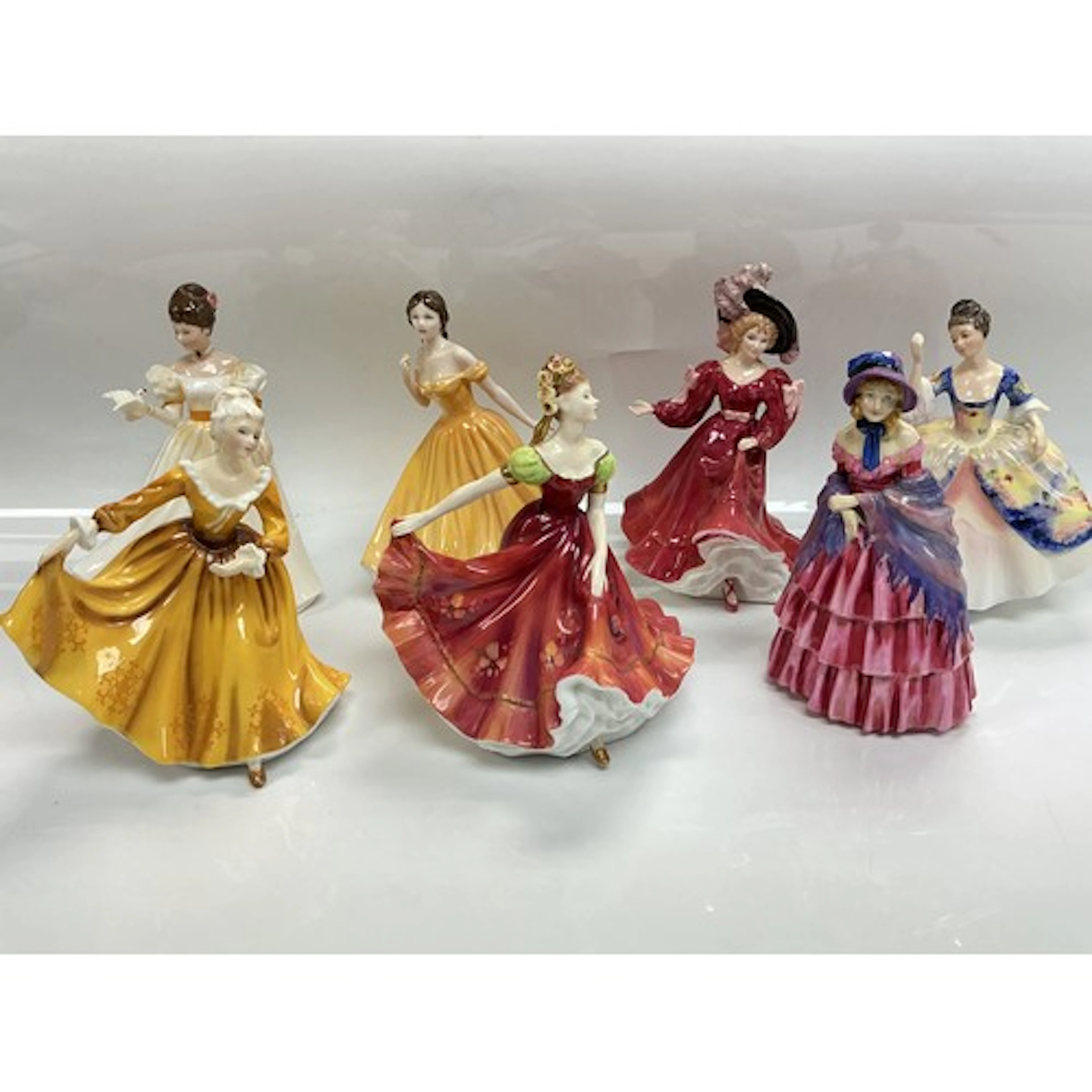Seven Royal Doulton figures comprising A Victorian Lady HN72...