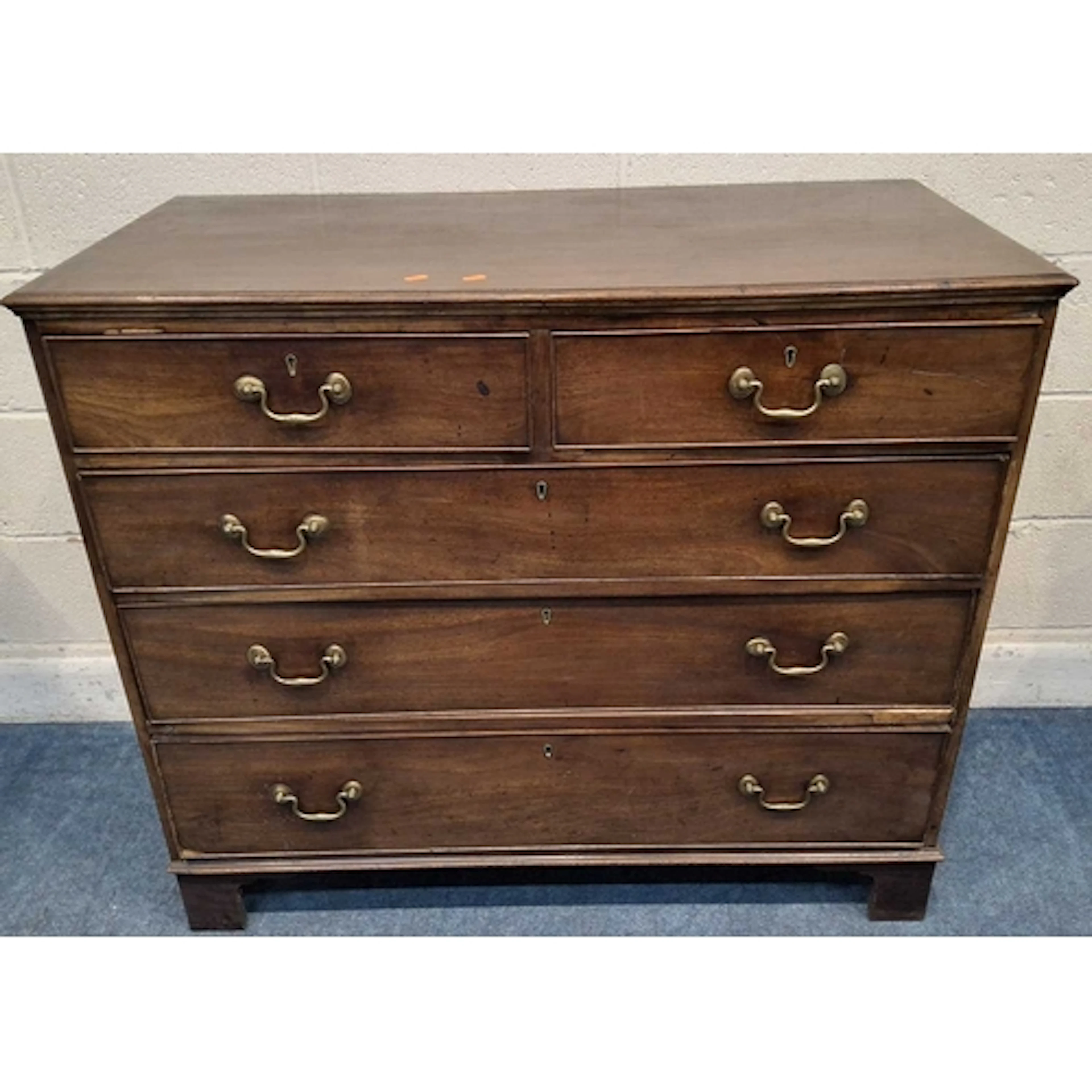 A GEORGIAN MAHOGANY CHEST OF TWO SHORT OVER THREE LONG GRADU...