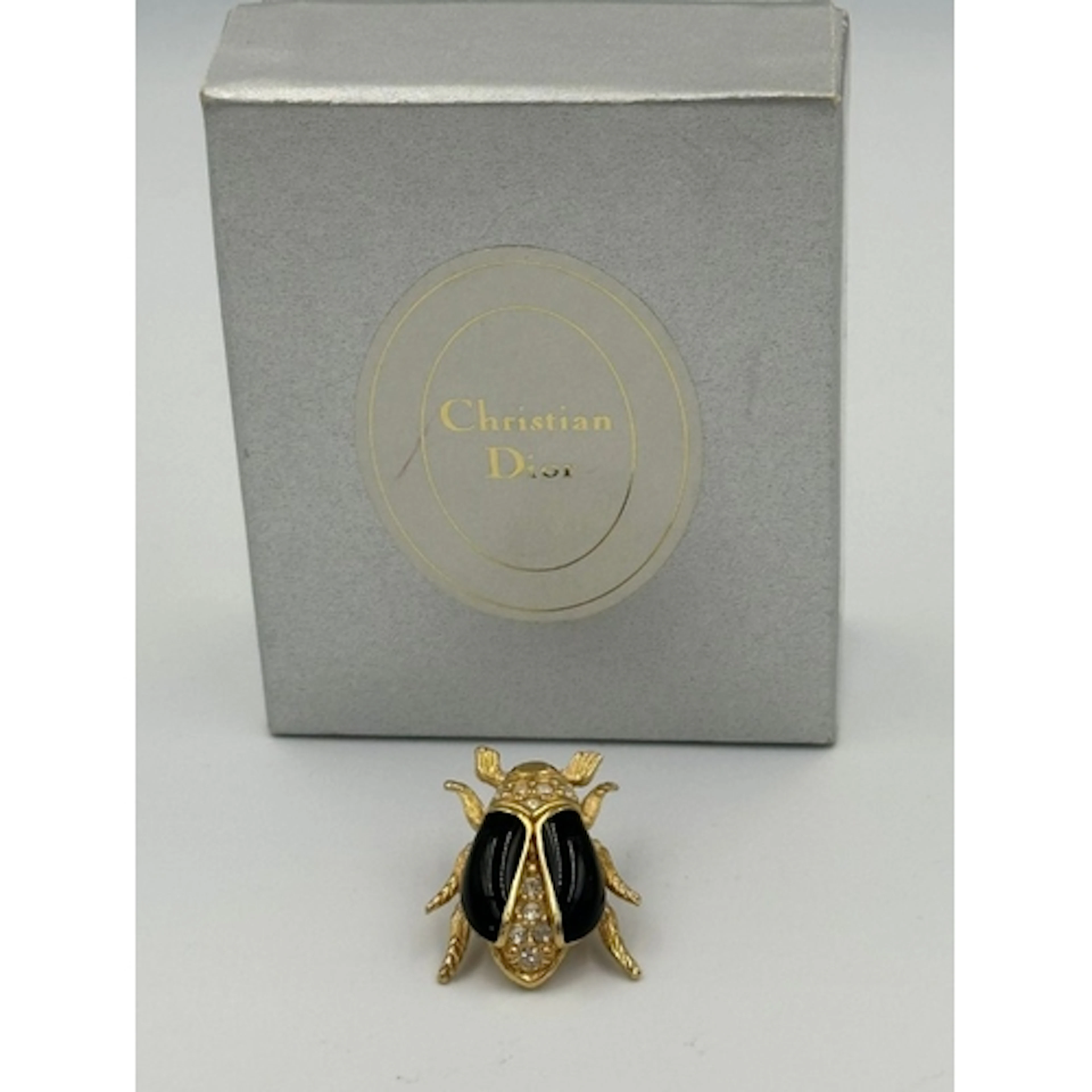 A Vintage Christian Dior Beetle brooch in original box.