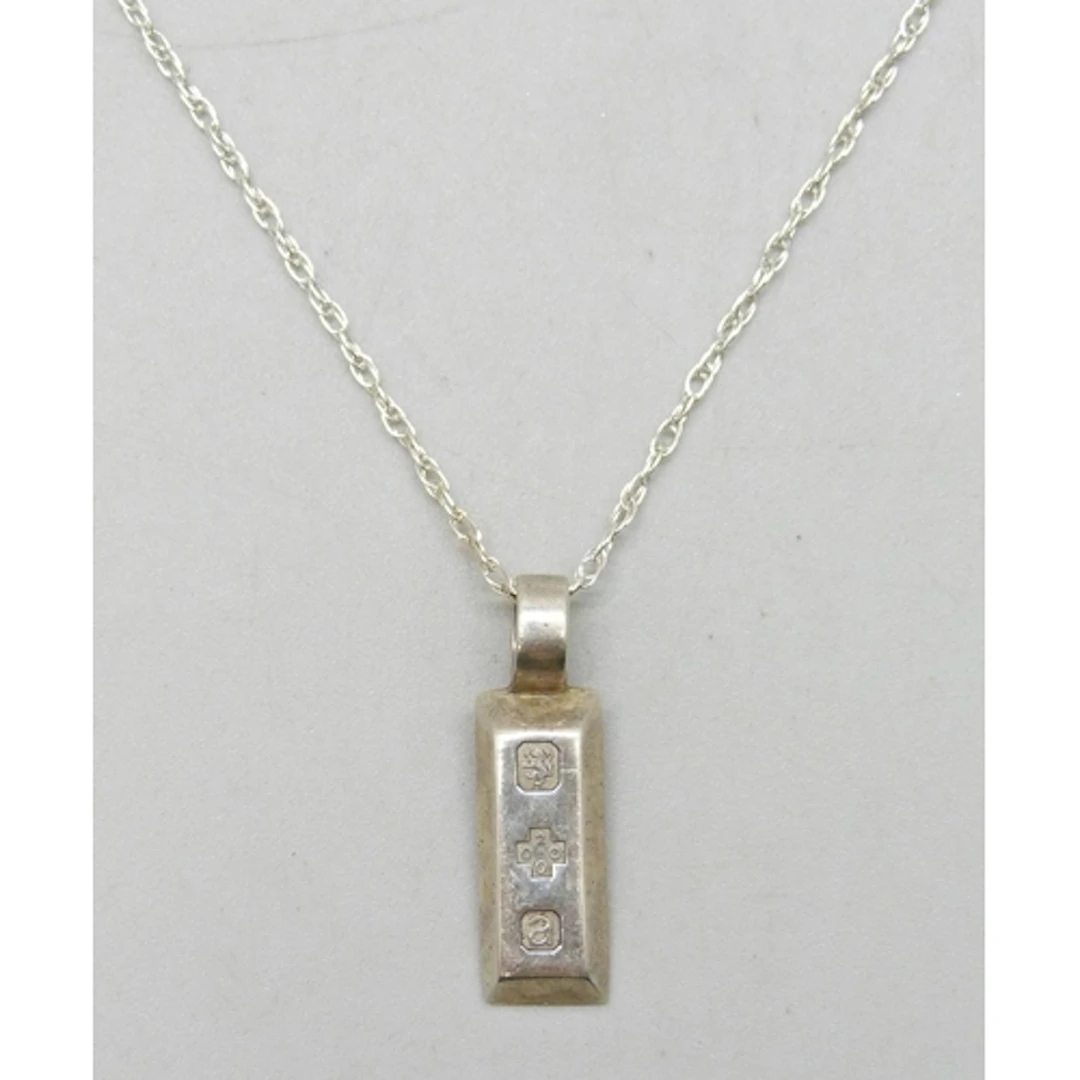 A Kit Heath small silver ingot pendant, 2.2cm, on a silver c...