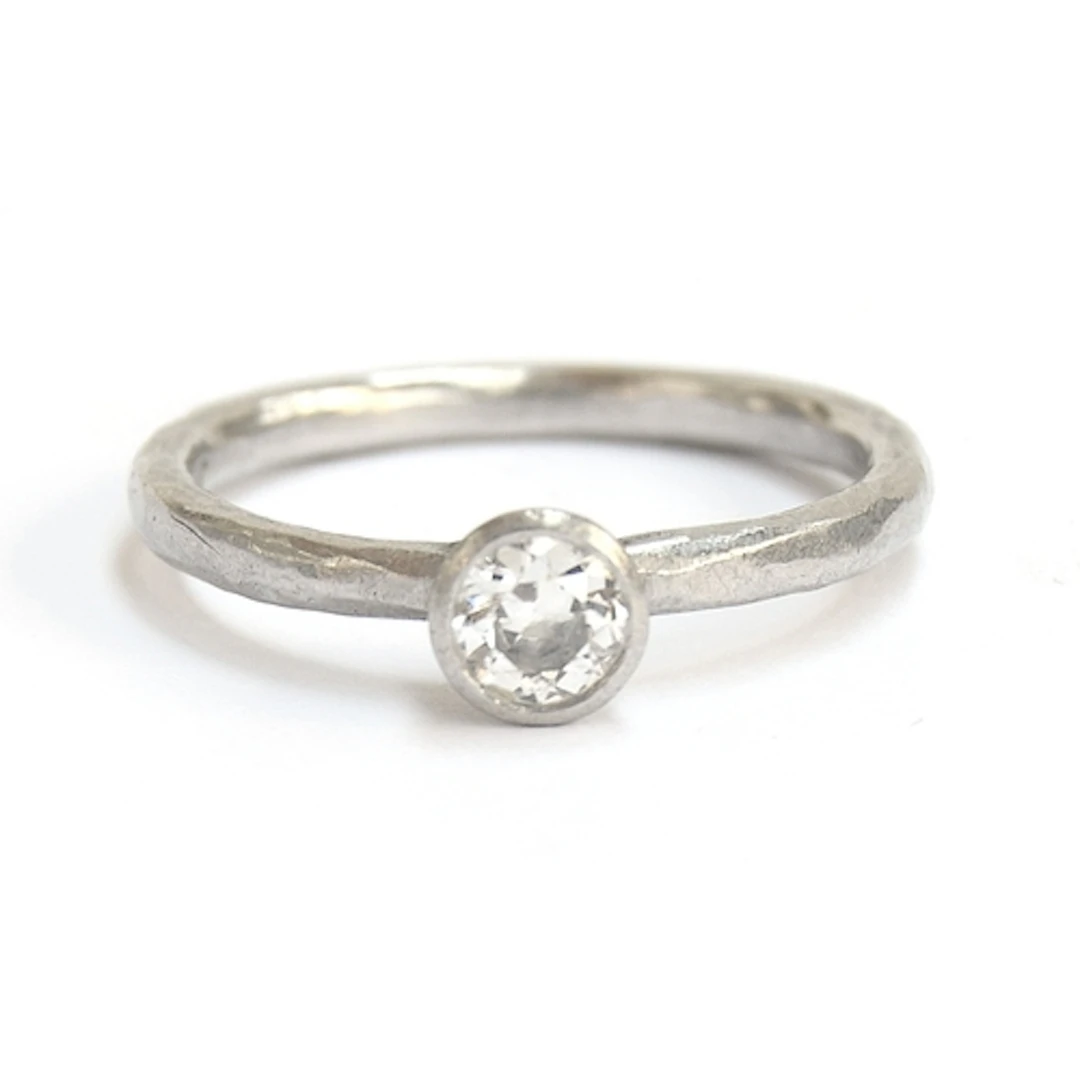 A Malcolm Betts platinum and diamond solitaire ring with ham...